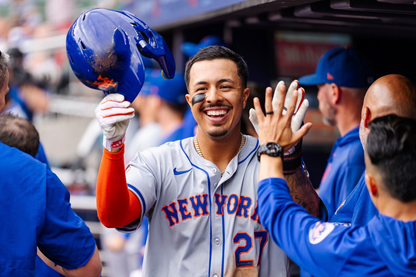 New York Mets' Mark Vientos celebrates in the dugout after scoring in the eighth inning of a baseball game against the Atlanta Braves, Monday, Sept. 30, 2024, in Atlanta. (AP Photo/Jason Allen)