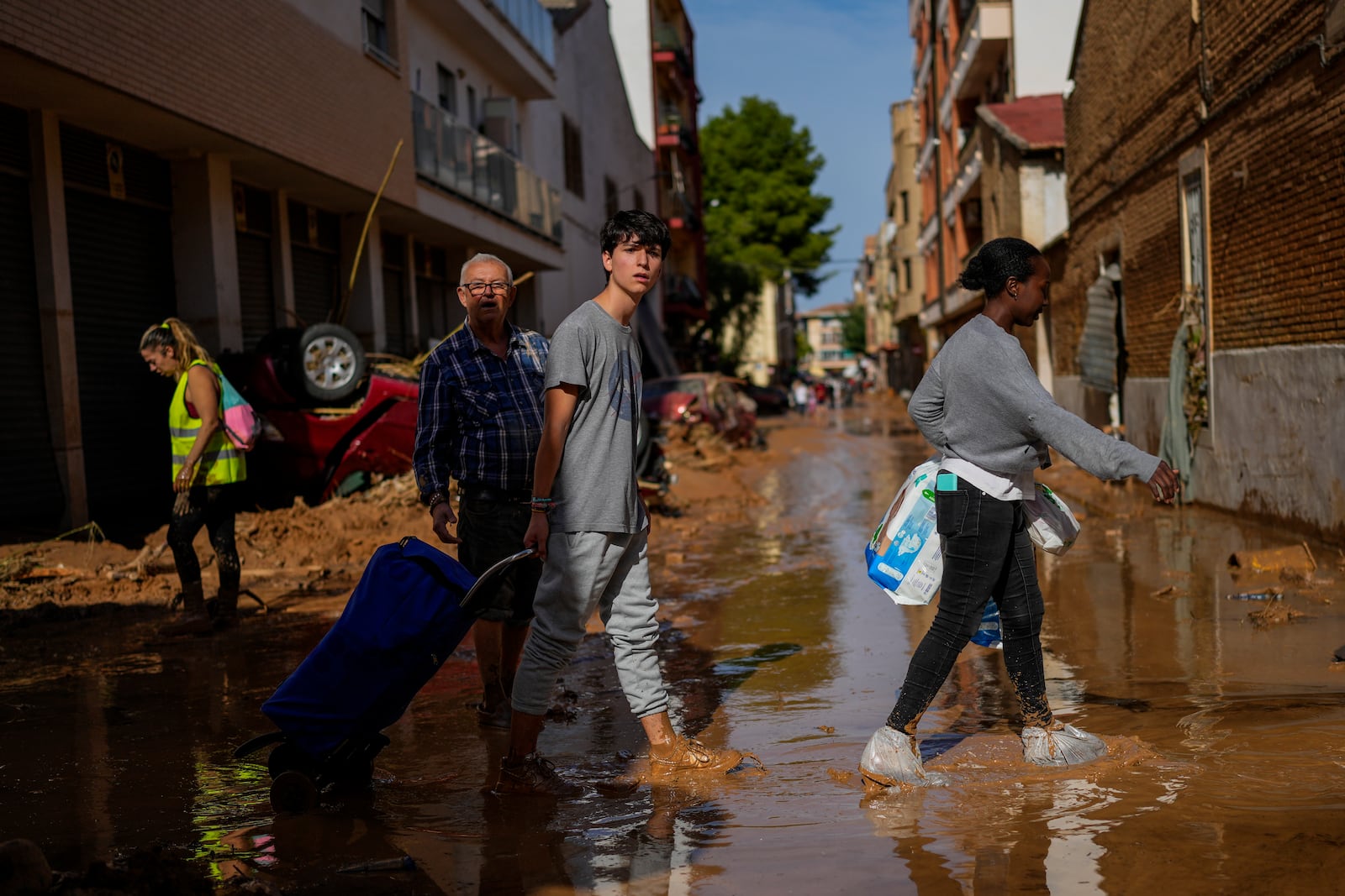 People walk in an area affected by floods in Valencia, Spain, Thursday, Oct. 31, 2024. (AP Photo/Manu Fernandez)