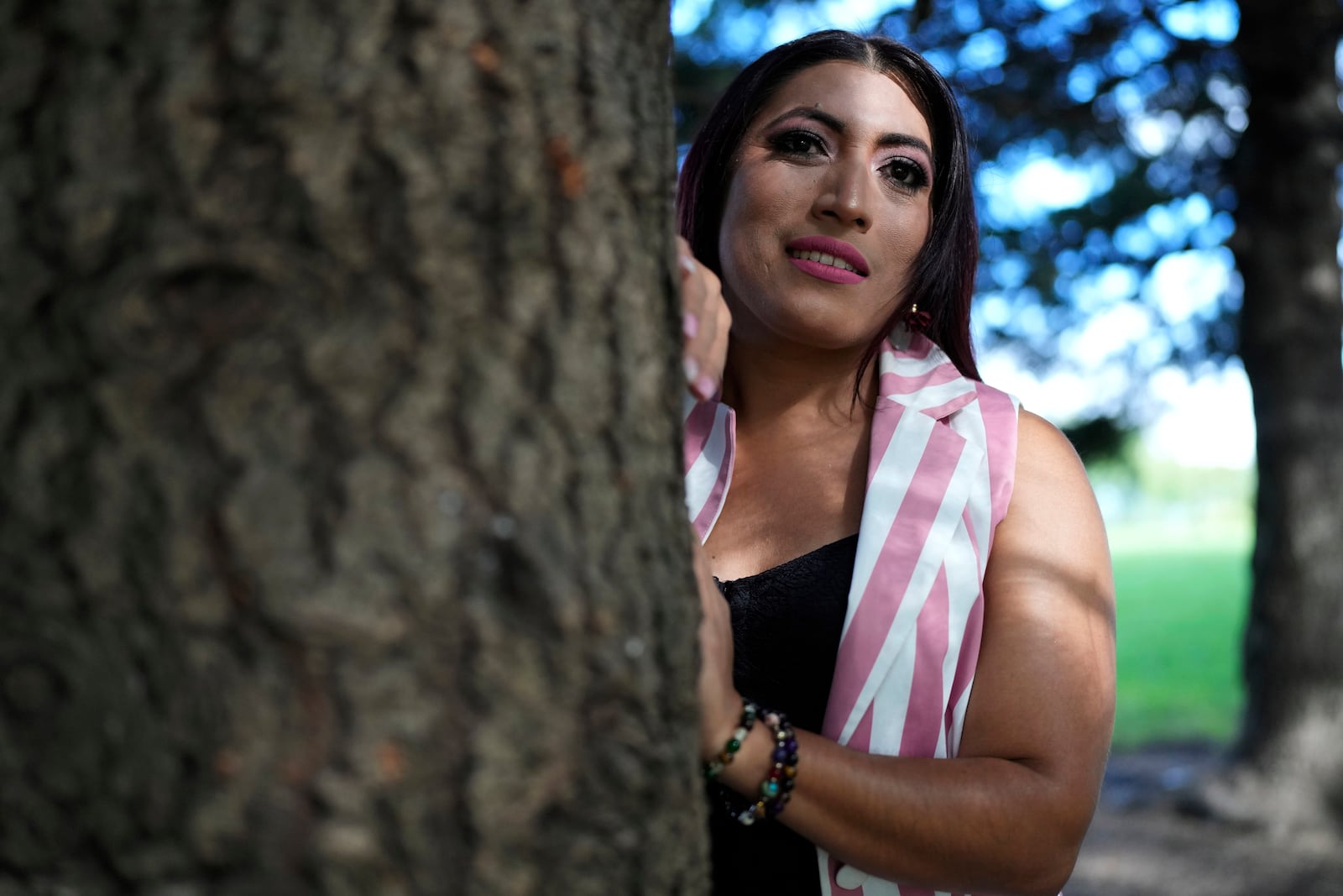 Julieth Luna Garcia, a transgender woman from El Salvador, poses for photos at Horner Park in Chicago, Monday, Sept. 30, 2024. (AP Photo/Nam Y. Huh)