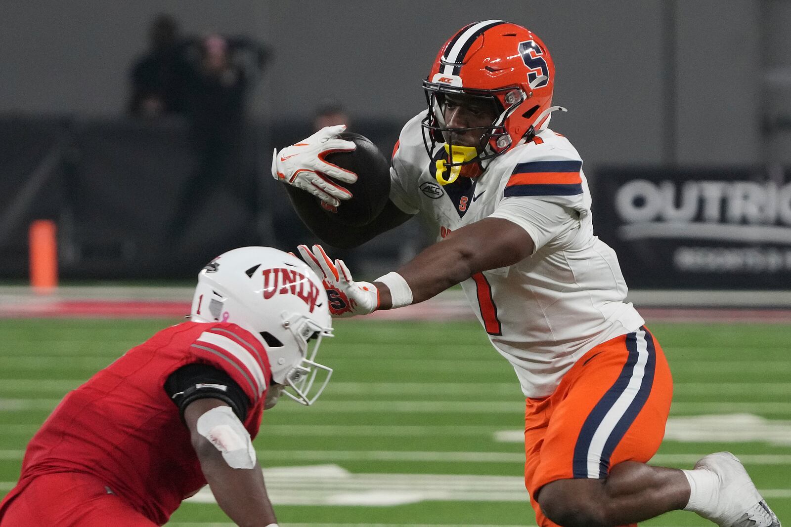 Syracuse wide receiver Jackson Meeks (7) stiff arms UNLV defensive back Jalen Catalon in the second half during an NCAA college football game, Friday, Oct. 4, 2024, in Las Vegas. (AP Photo/Rick Scuteri)