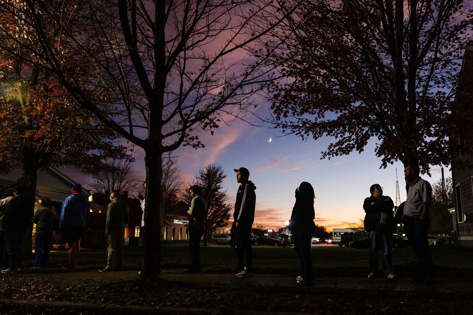 Levi Zoltowski, center, from St. Charles, waits in line to vote in the presidential election on Tuesday, Nov. 5, 2024, at St. Charles Christian Church in the New Town area of St. Charles, Mo. (Zachary Linhares/St. Louis Post-Dispatch via AP)