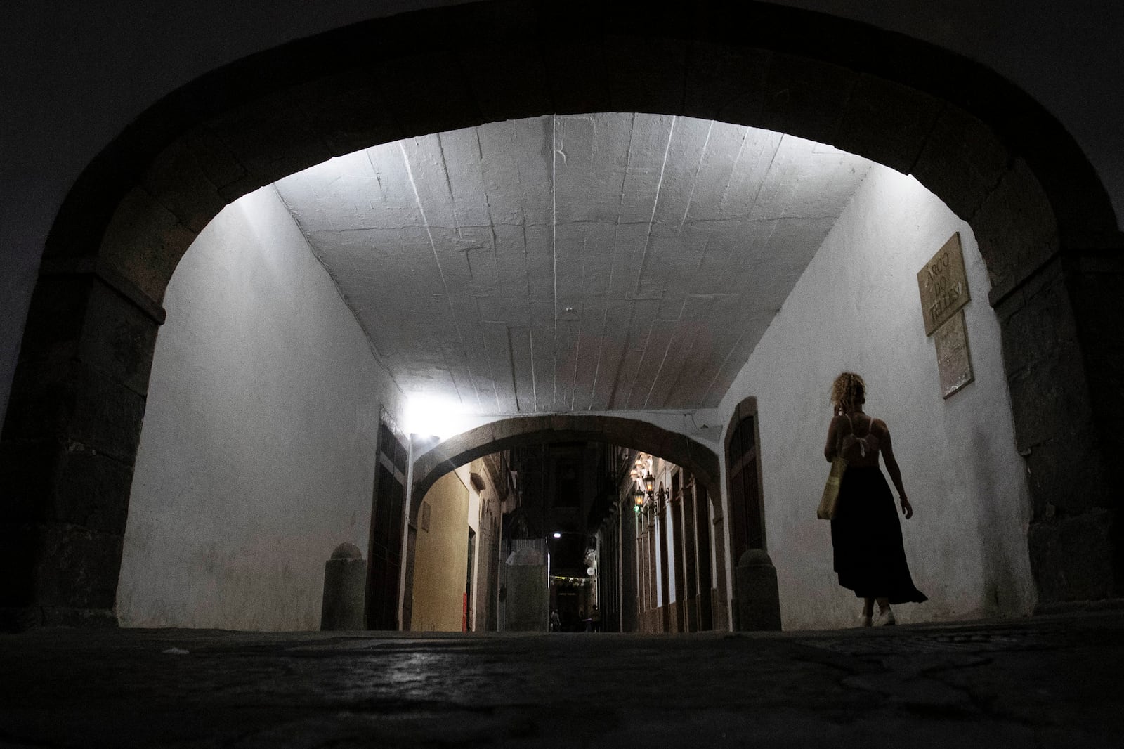 A woman walks in an important Brazilian historical construction from the 18th century named Arco do Teles, in Rio de Janeiro, Friday, Oct. 25, 2024. (Bruna Prado/AP Photo)