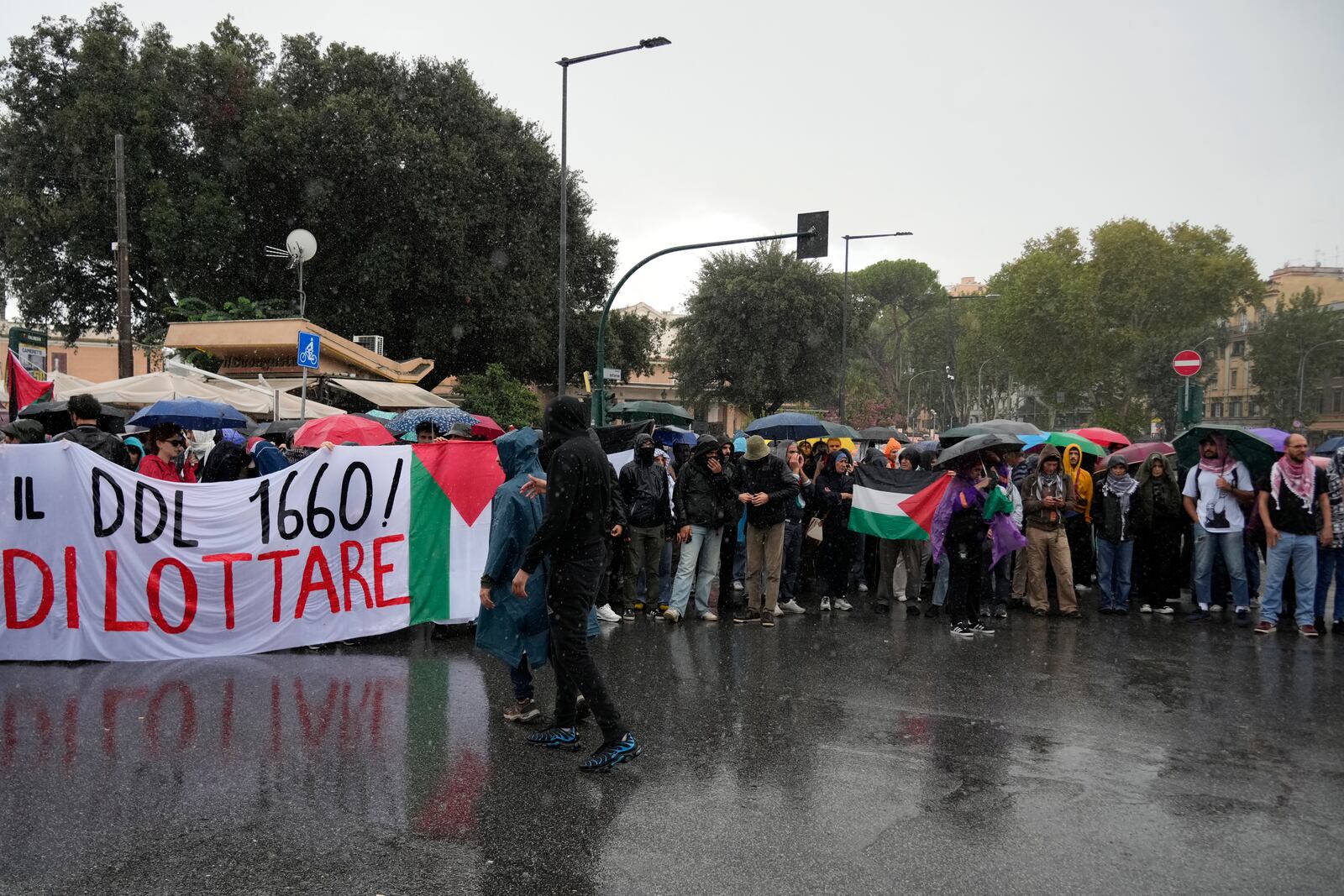 People stand during a protest in Rome, Saturday, Oct. 5, 2024. Pro-palestinians people take to the street in an unauthorised march in the centre of Rome two days ahead of the first anniversary of the Oct. 7. (AP Photo/Andrew Medichini)