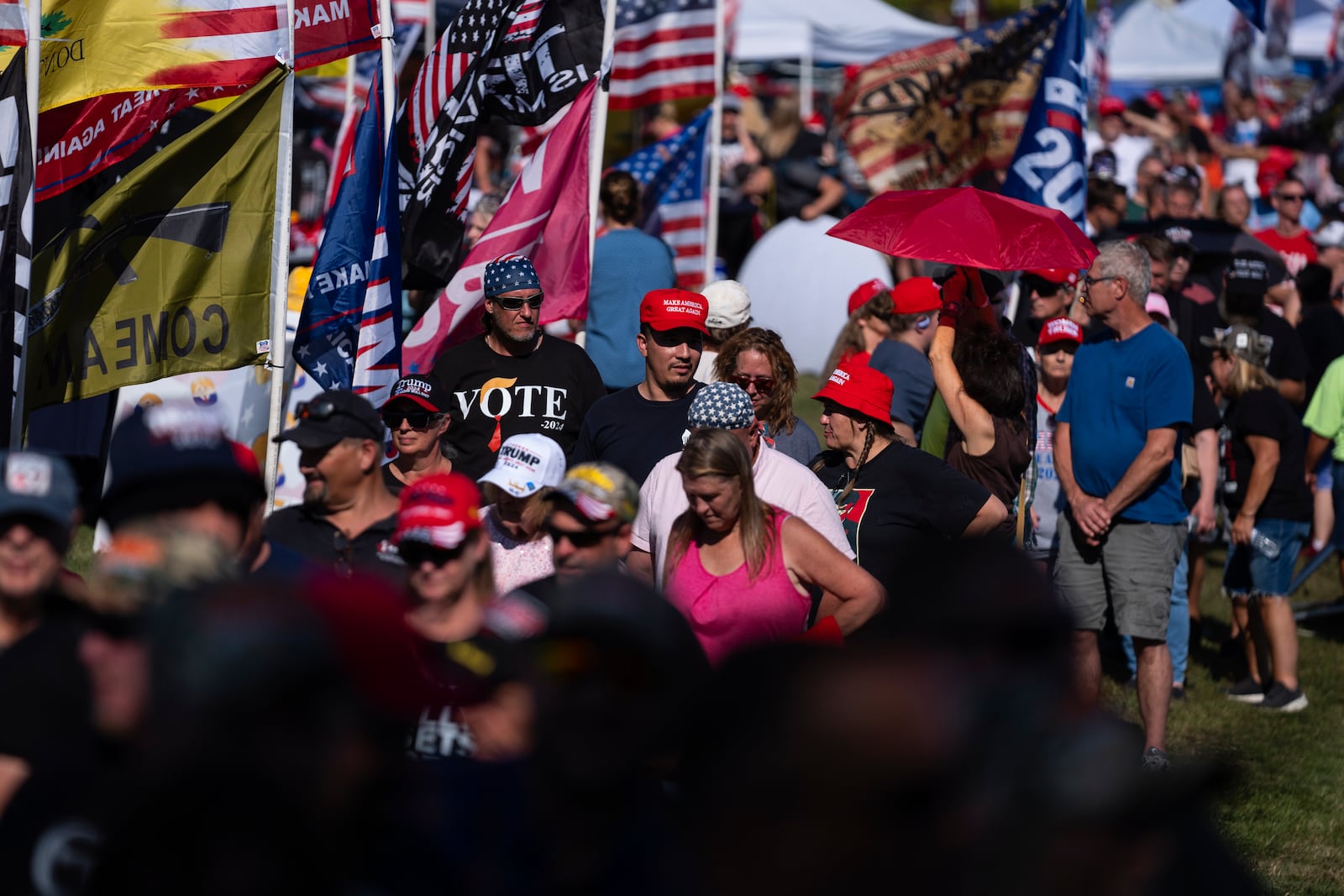 People wait in line to attend a town hall with Republican presidential candidate former President Donald Trump at the Dort Financial Center, Tuesday, Sept. 17, 2024, in Flint, Mich. (AP Photo/Evan Vucci)