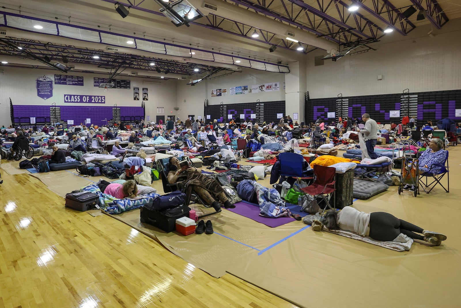 A view of some of the 700 evacuees in the gymnasium in shelter at River Ridge Middle/High School in preparation for Hurricane Milton on Wednesday, Oct. 9, 2024, in New Port Richey, Fla. (AP Photo/Mike Carlson)