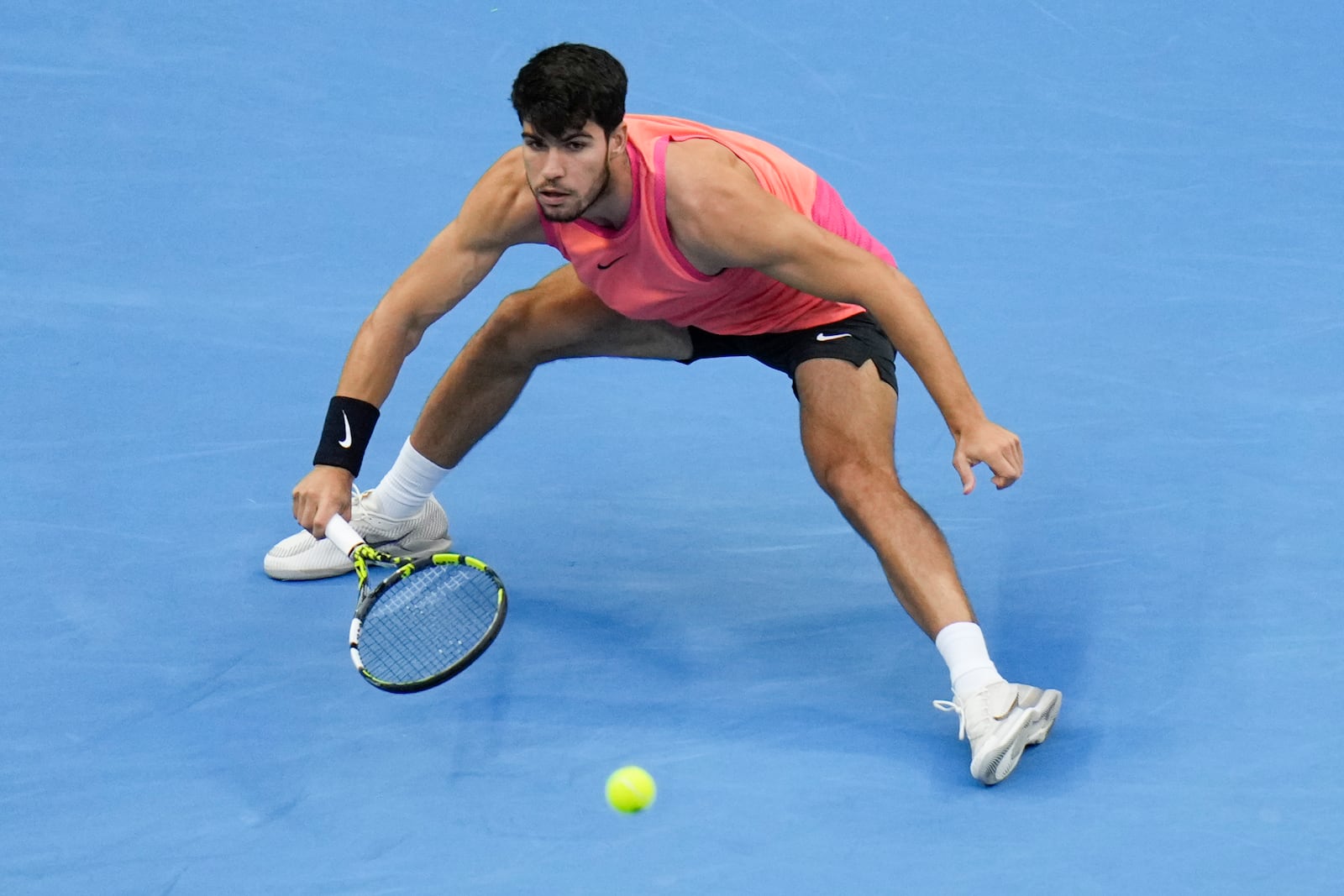 Carlos Alcaraz of Spain returns a shot from Jannik Sinner of Italy during their men's singles finals match of the China Open tennis tournament, at the National Tennis Center in Beijing, Wednesday, Oct. 2, 2024. (AP Photo/Andy Wong)