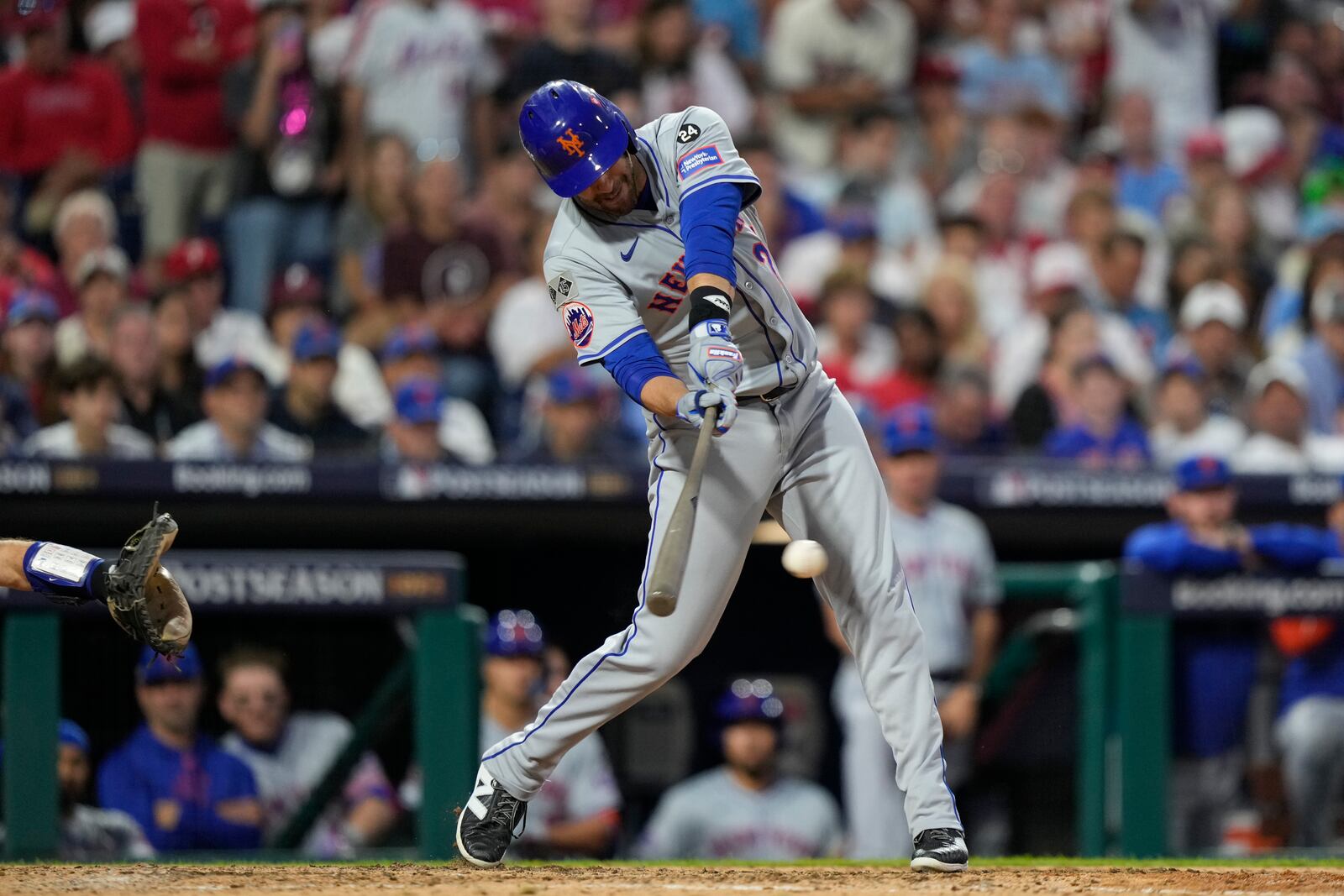 New York Mets' J.D. Martinez hits an RBI single off Philadelphia Phillies pitcher Orion Kerkering during the eighth inning of Game 1 of a baseball NL Division Series, Saturday, Oct. 5, 2024, in Philadelphia. (AP Photo/Matt Slocum)