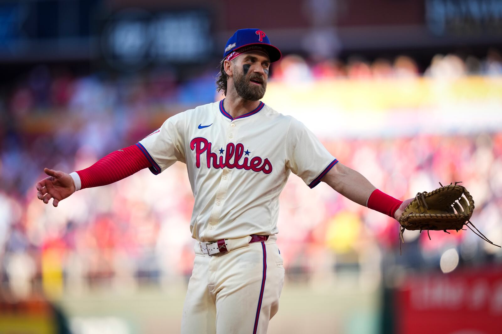 Philadelphia Phillies first base Bryce Harper talks with an umpire during the fourth inning of Game 1 of a baseball NL Division Series against the New York Mets, Saturday, Oct. 5, 2024, in Philadelphia. (AP Photo/Matt Slocum)