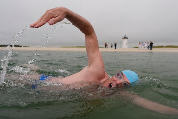 Endurance swimmer Louis Pugh swims near the Edgartown Harbor Light, Thursday, May 15, 2025, in Edgartown, Mass. (AP Photo/Robert F. Bukaty)