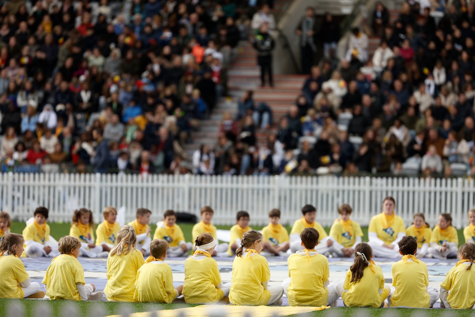 Kids listen Pope Francis as he presides the holy mass , at the King Baudouin stadium in Brussels, Belgium, Sunday, Sept. 29, 2024. (AP Photo/Omar Havana)