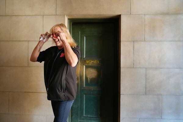 FILE - Jessie McGrath walks out of the women's bathroom at the Nebraska State Capitol in Lincoln, Neb., on Wednesday, Oct. 2, 2024. McGrath said when she was testifying against LB575, "I actually used it (the women's restroom) with a number of you senators today, and I don't think that the world has come to an end, has it?" (AP Photo/Brynn Anderson, File)