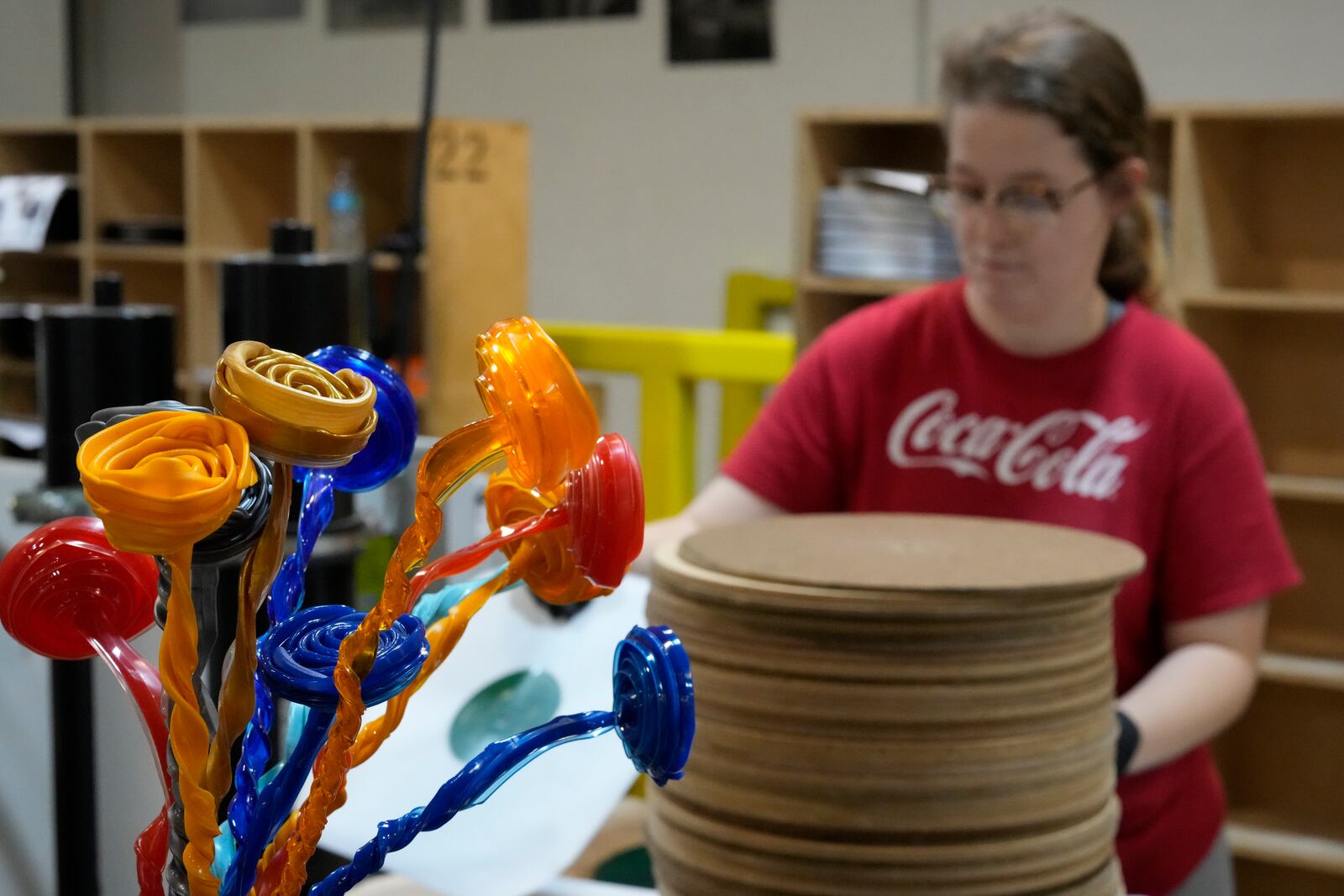 A bouquet of vinyl flowers are seen as Tannika Benjamin works at the United Record Pressing plant July 11, 2024, in Nashville, Tenn. (AP Photo/George Walker IV)