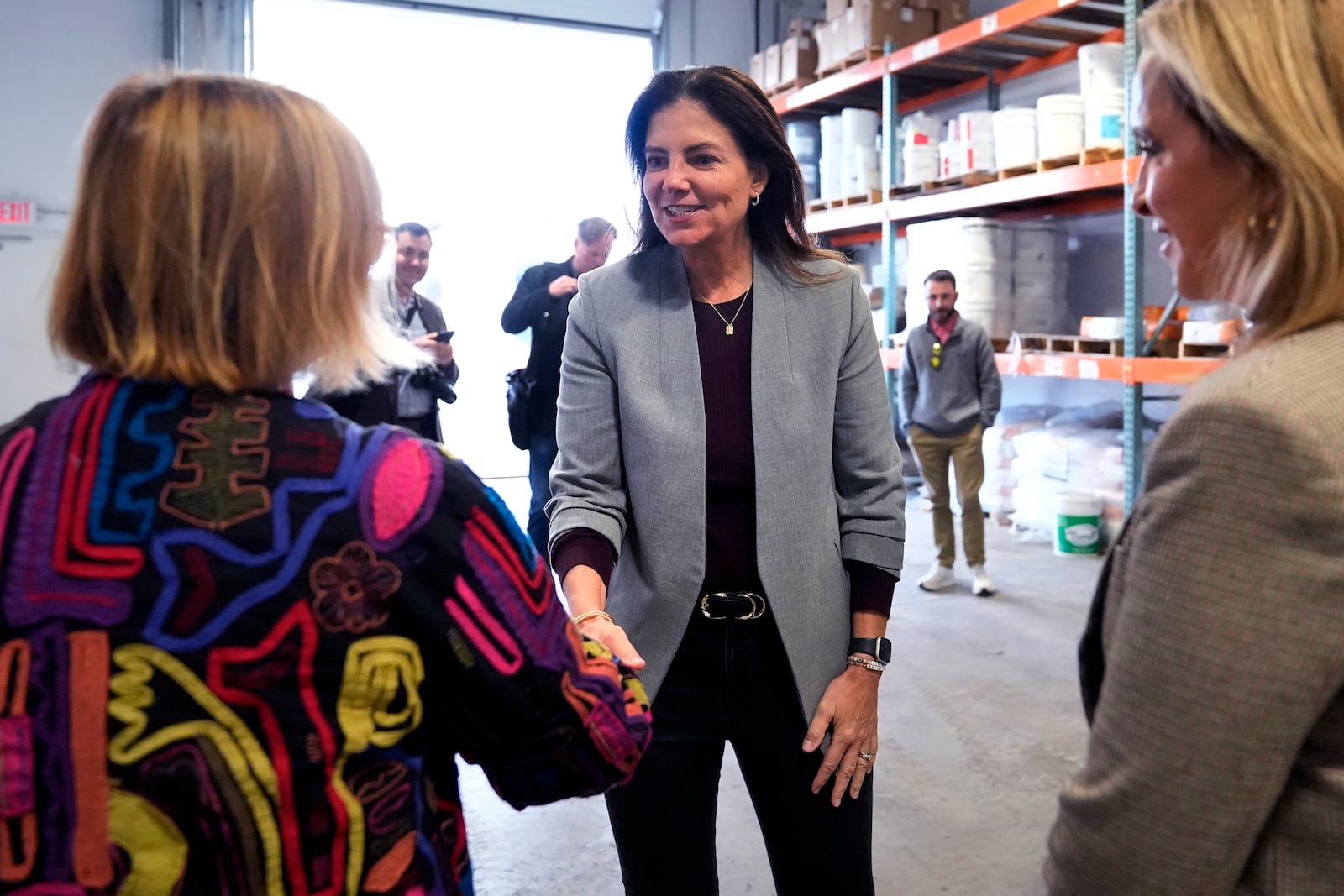 Republican gubernatorial candidate Kelly Ayotte, who faces Democrat Joyce Craig in the November 2024 election, shakes hands with administrators during a visit to a local concrete coating business, Wednesday, Oct. 16, 2024, in Manchester, N.H. (AP Photo/Charles Krupa)