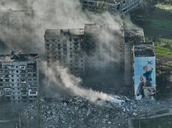 FILE - Smoke rises from a building in Bakhmut, the site of the heaviest battles with the Russian troops in the Donetsk region, Ukraine, Wednesday, April 26, 2023. (AP Photo/Libkos, File)