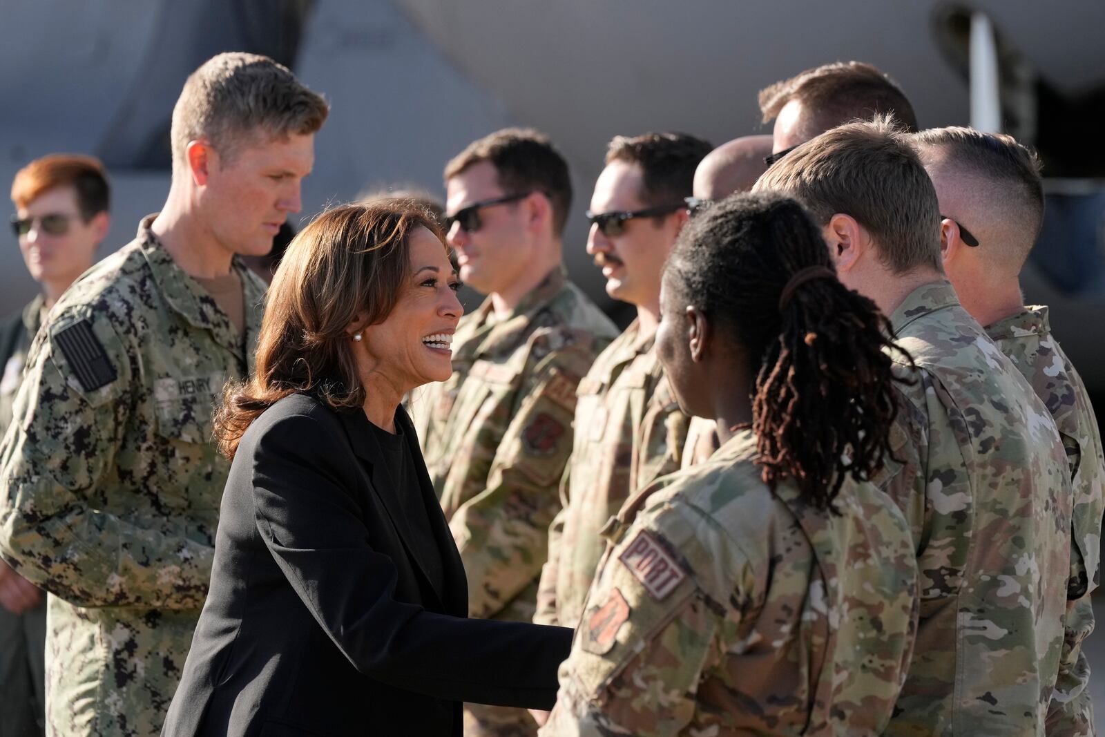 Democratic presidential nominee Vice President Kamala Harris greets members of the military near a C-17 cargo plane after receiving a briefing on the damage from Hurricane Helene, Saturday, October 5, 2024, at the North Carolina Air National Guard in Charlotte, N.C. (AP Photo/Chris Carlson)