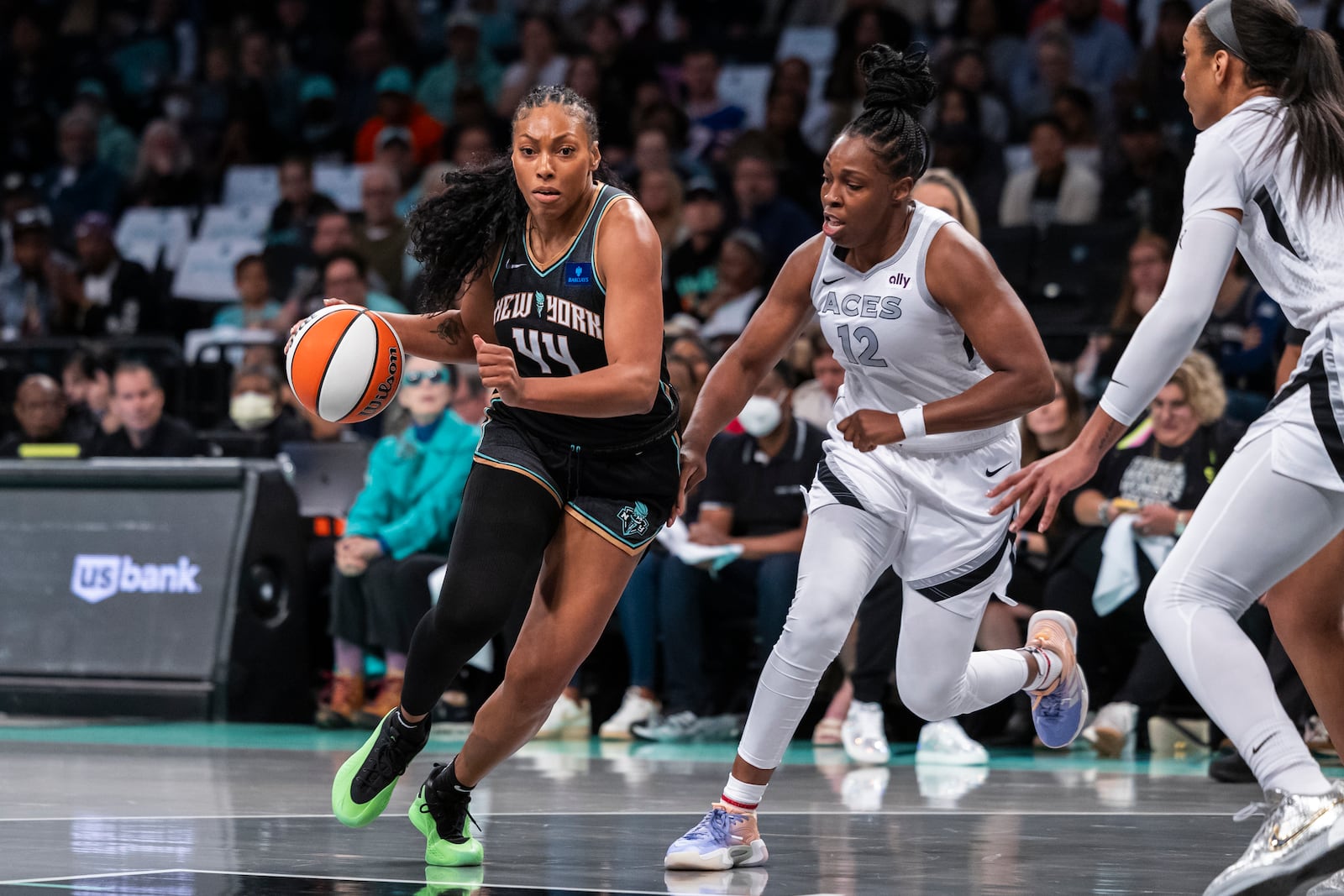 New York Liberty forward Betnijah Laney-Hamilton (44) is defended by Las Vegas Aces guard Chelsea Gray (12) during the first half of a WNBA basketball second-round playoff game, Sunday, Sept. 29, 2024, in New York. (AP Photo/Corey Sipkin)