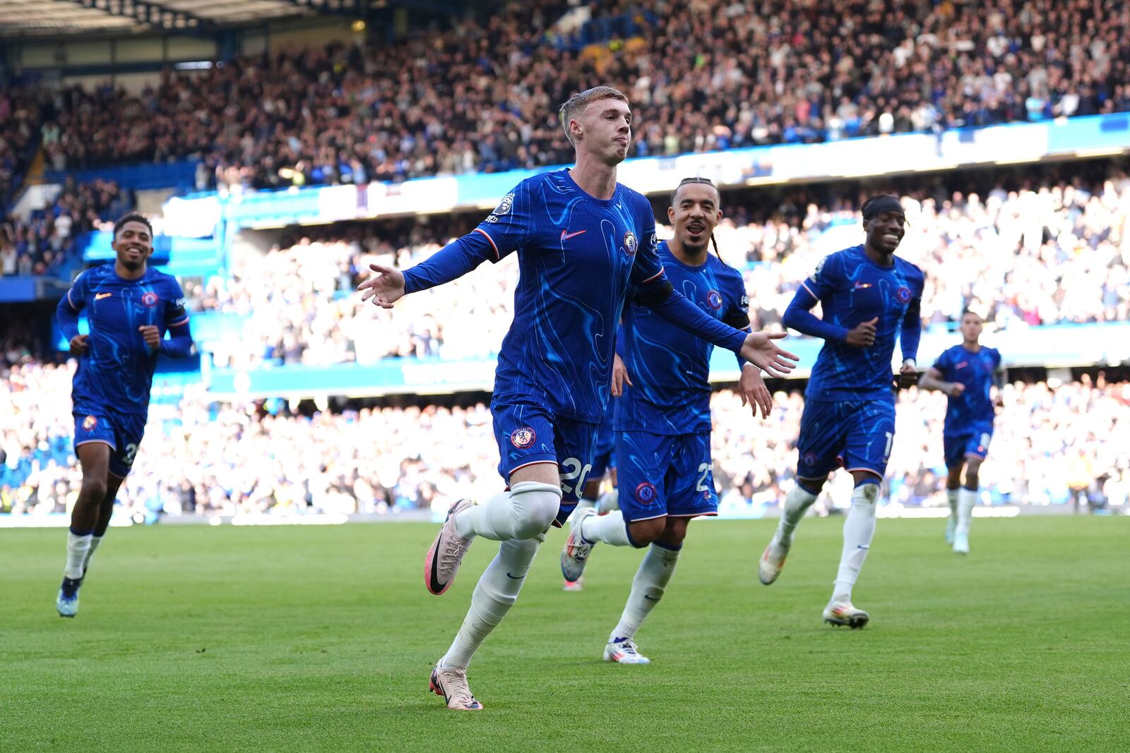 Chelsea's Cole Palmer (centre) celebrates scoring his side's second goal of the game with team-mates during a British Premier League soccer match between Chelsea and Brighton at Stamford Bridge, London, Saturday, Sept. 28, 2024. (Bradley Collyer/PA via AP)