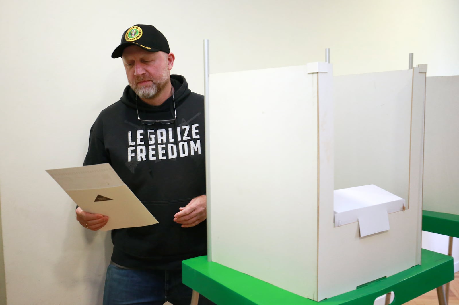 Zurab Japaridze, co-founder and chair of the Libertarian party, holds his ballot at a polling station during the parliamentary election in Tbilisi, Georgia, Saturday, Oct. 26, 2024. (AP Photo/Zurab Tsertsvadze)