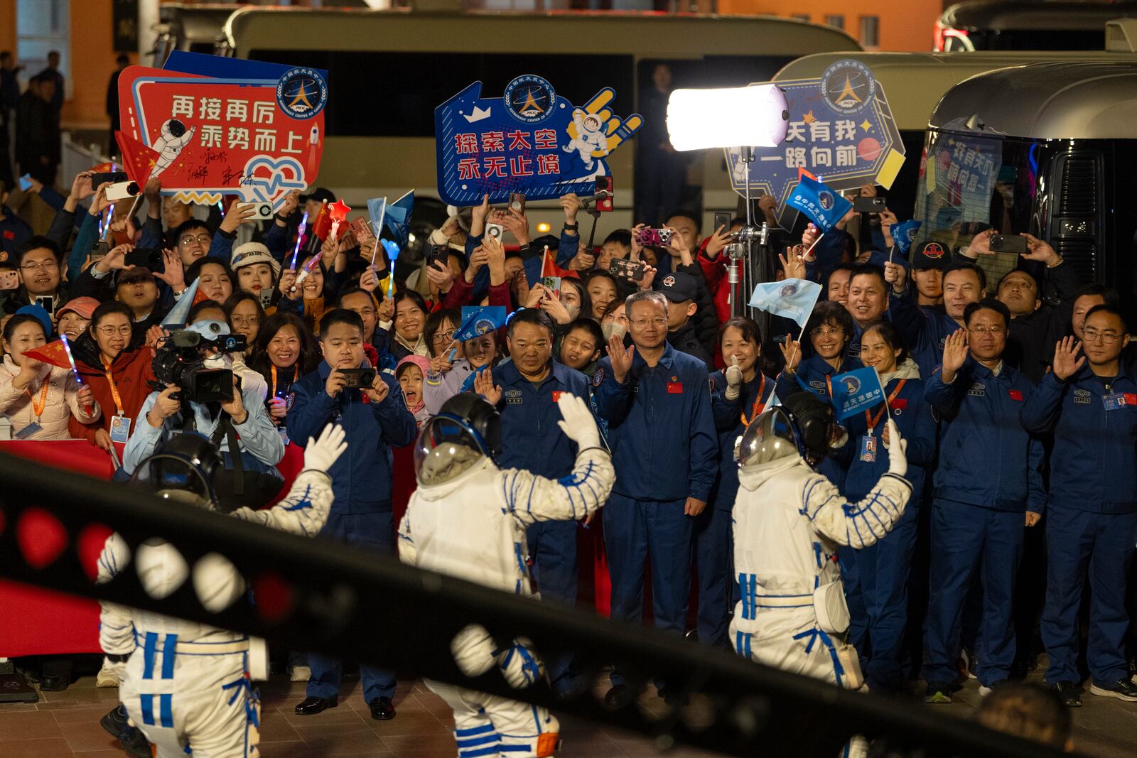 Chinese astronauts Wang Haoze, from left, Song Lingdong and Cai Xuzhe wave during the see-off ceremony for the Shenzhou-19 mission at the Jiuquan Satellite Launch Center in northwestern China, in the early hours of Wednesday, Oct. 30, 2024. (AP Photo/Ng Han Guan)