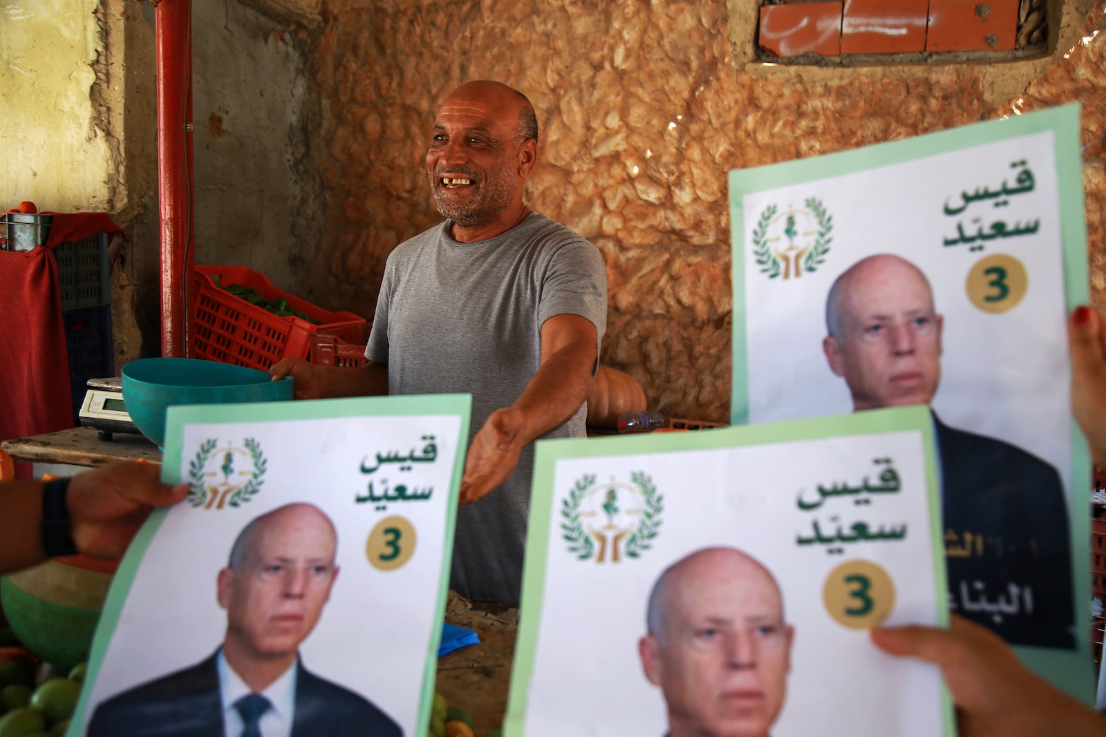 Supporters of Tunisian President and candidate for re-election Kais Saied meet with residents of a neighbourhood during a campaign tour, in Ariana, Tunisia, Thursday, Sept. 26, 2024. (AP Photo/Anis Mili)