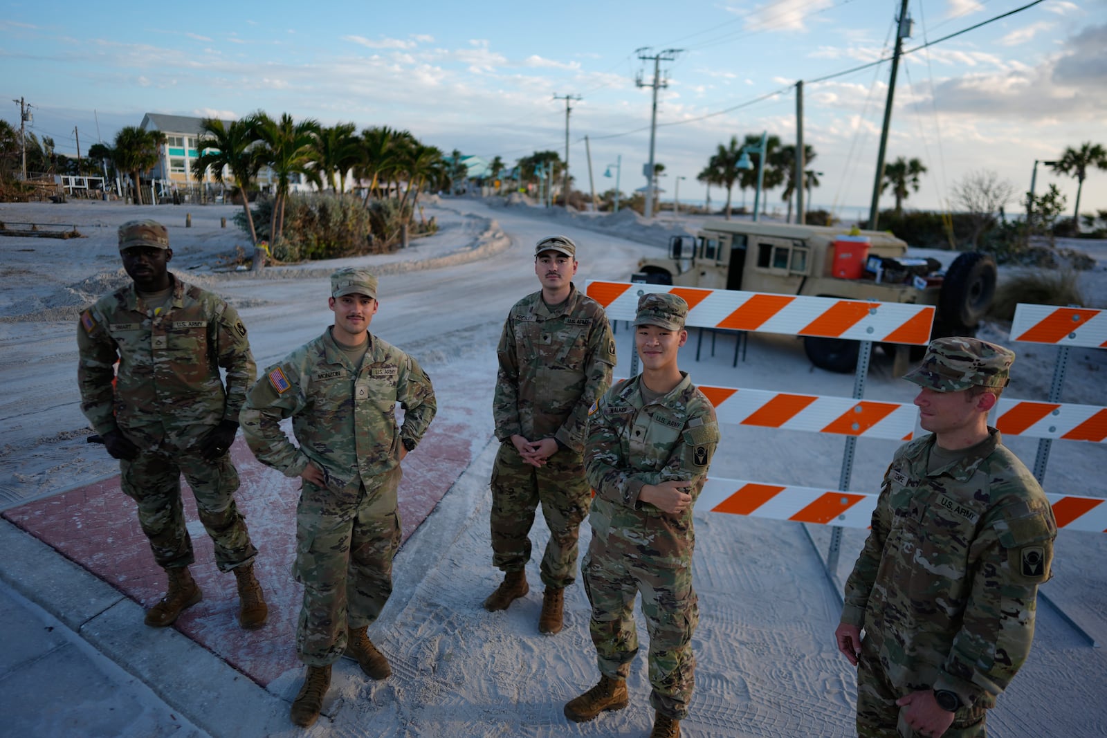 Florida National Guardsmen control access to a heavily damaged area of Manasota Key, Fla., following the passage of Hurricane Milton, Saturday, Oct. 12, 2024. (AP Photo/Rebecca Blackwell)