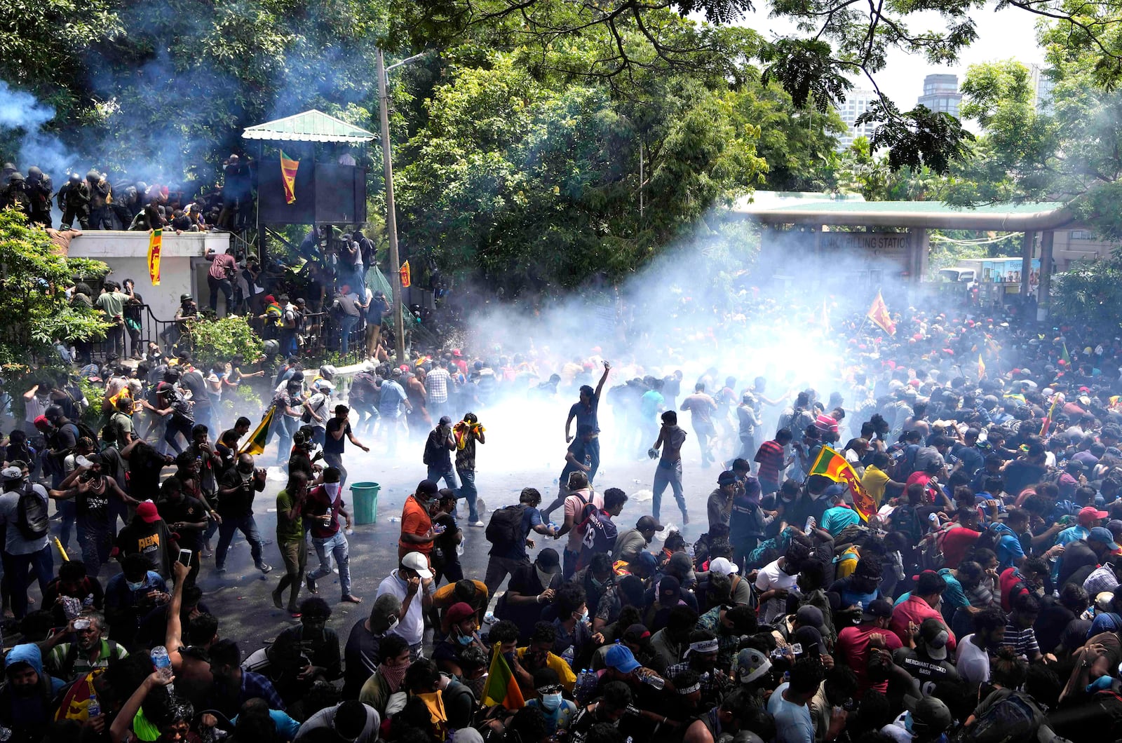 FILE - Police fire tear gas as protesters stormed the compound of Prime Minister Ranil Wickremesinghe demanding he resign after President Gotabaya Rajapaksa fled the country amid an economic crisis in Colombo, Sri Lanka, on July 13, 2022. (AP Photo/Eranga Jayawardena, File)