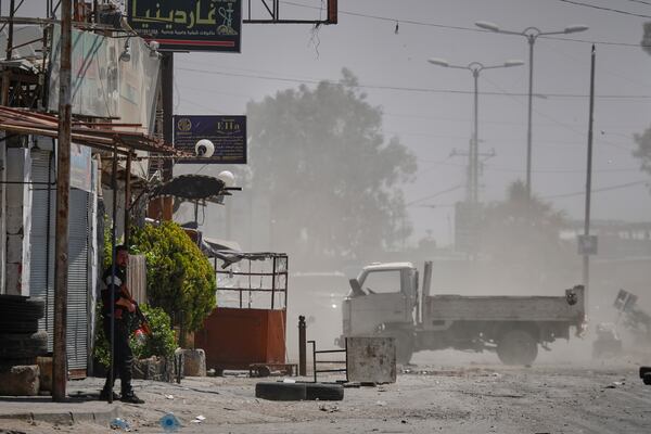 A Druze gunmen stands guard near a checkpoint a day after clashes between members of the minority Druze sect and pro-government fighters left at least four people dead in the southern suburb of Jaramana, Damascus, Syria, Tuesday, April 29, 2025. (AP Photo/Omar Sanadiki)