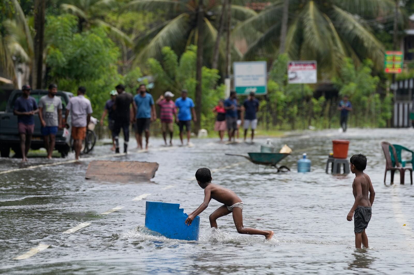 Children play in a flooded street in Colombo, Sri Lanka, Sunday, Oct. 13, 2024. (AP Photo/Eranga Jayawardena)