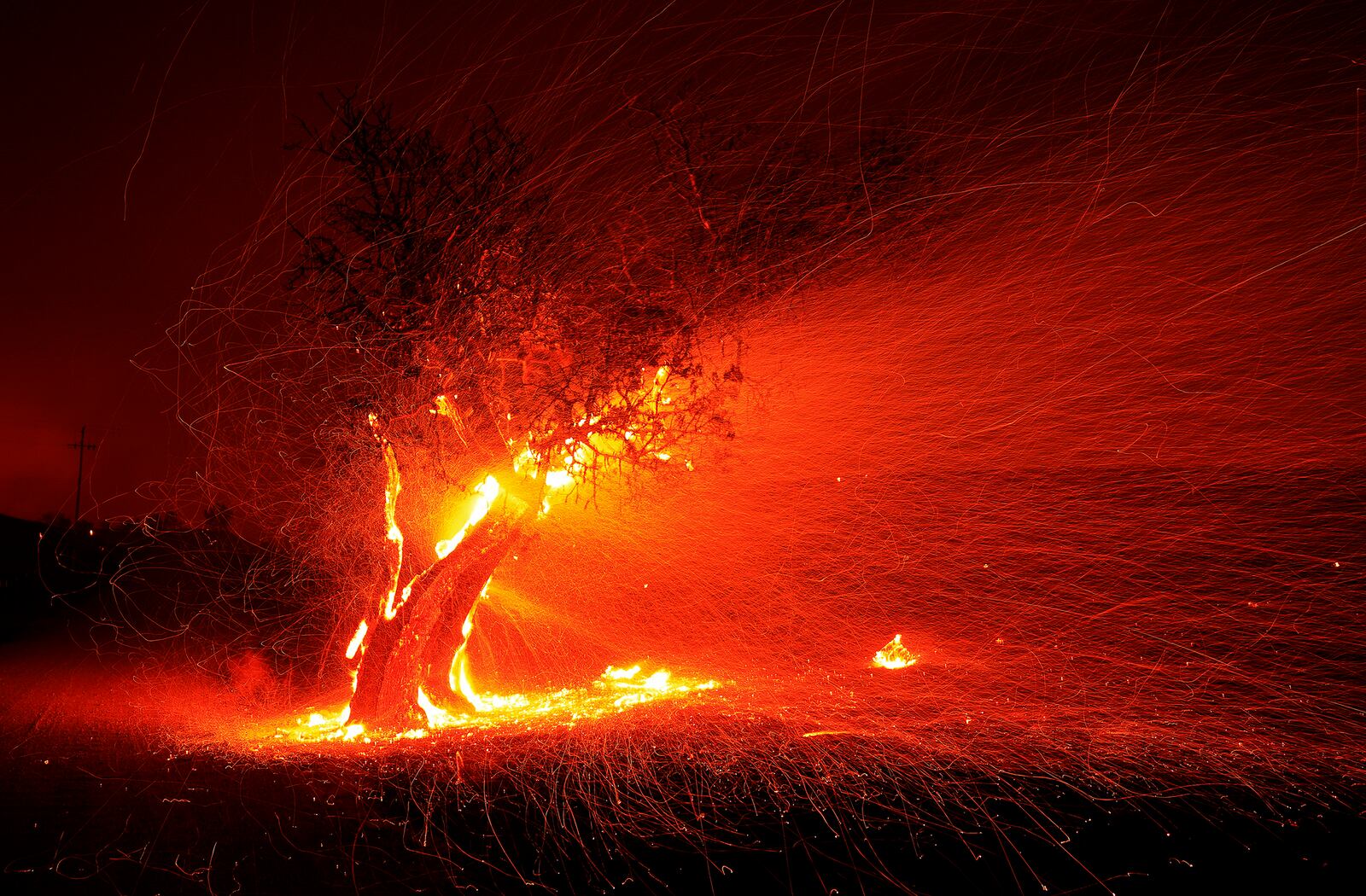 FILE - An ember wash spreads over the landscape pushed by high winds during the Kincade fire in the Geysers, Thursday, Oct. 24, 2019, in Sonoma County, Calif. (Kent Porter/The Press Democrat via AP, File)