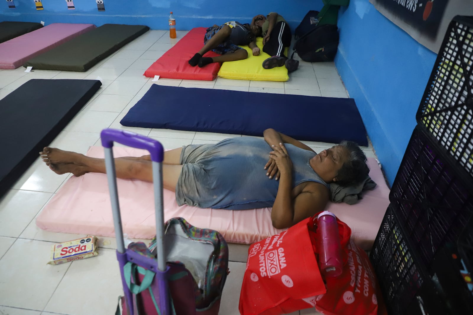 People rest in a refugee shelter prior to the arrival of Hurricane Milton, in Progreso, Yucatan state, Mexico, Monday, Oct. 7, 2024. (AP Photo/Martin Zetina)