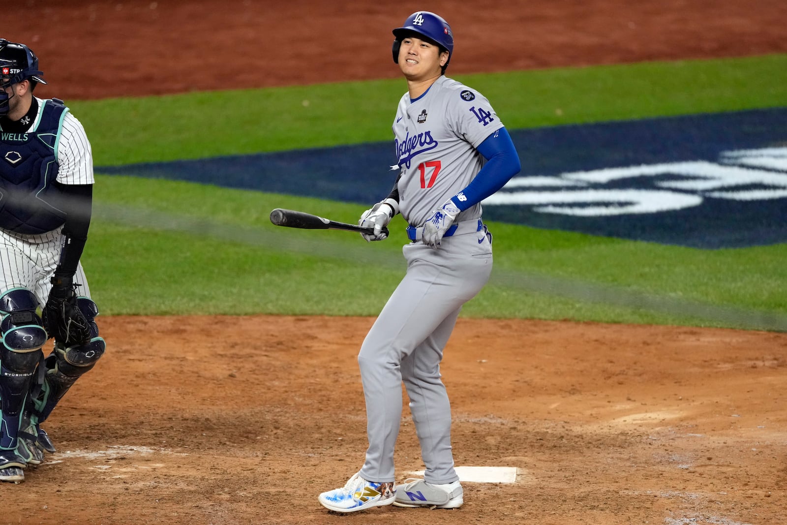 Los Angeles Dodgers' Shohei Ohtani reacts after being hit in the foot by a pitch during the ninth inning in Game 3 of the baseball World Series against the New York Yankees, Monday, Oct. 28, 2024, in New York. (AP Photo/Seth Wenig)