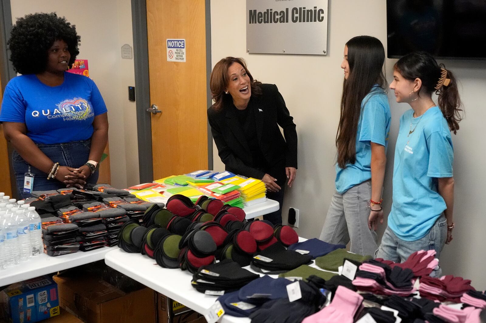 Democratic presidential nominee Vice President Kamala Harris, second left, greets workers at a food drop-off and distribution center after receiving a briefing on the damage from Hurricane Helene, Saturday, October 5, 2024, in Charlotte, N.C. (AP Photo/Chris Carlson)