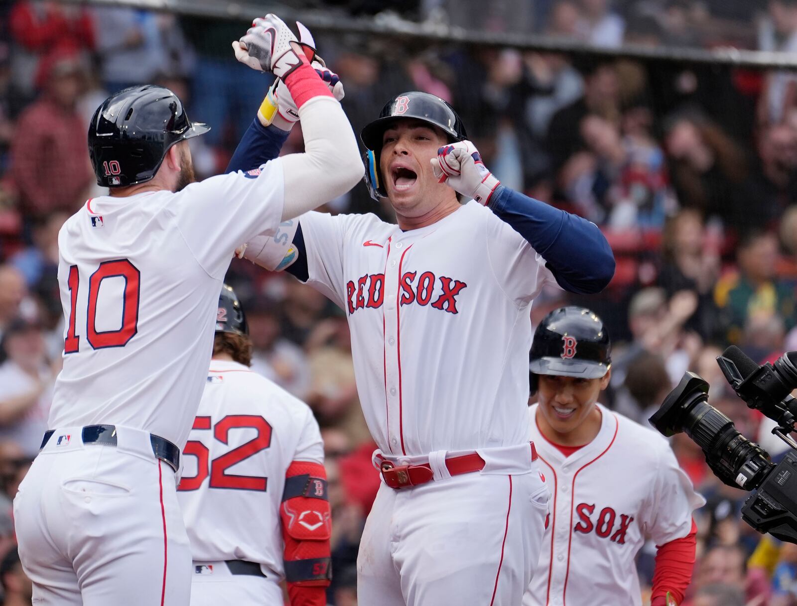 Boston Red Sox's Triston Casas, center, celebrates after his three-run home run that also drove in Trevor Story (10) and Masataka Yoshida, back right, during the third inning of the first game of a baseball doubleheader against the Minnesota Twins, Sunday, Sept. 22, 2024, in Boston. (AP Photo/Michael Dwyer)