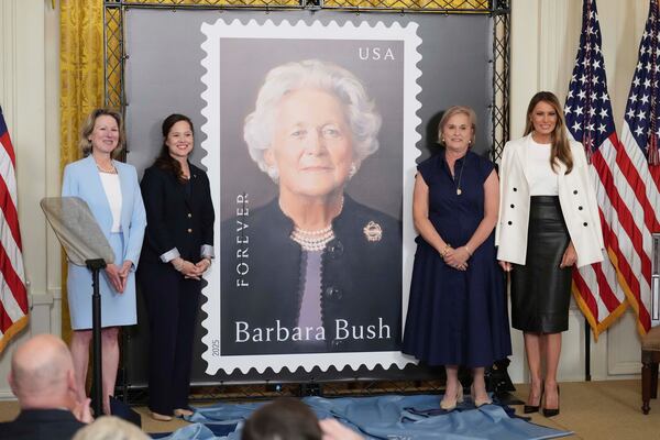 First lady Melania Trump, from right, Dorothy Bush Koch, Alice Gonzalez Yates, CEO of the George and Barbara Bush Foundation, and Judy de Torok, vice president of corporate affairs at the U.S. Postal Service, unveil a U.S. Postal Service Stamp honoring former first lady Barbara Bush, Thursday, May 8, 2025, in the East Room of the White House in Washington. (AP Photo/Jacquelyn Martin)