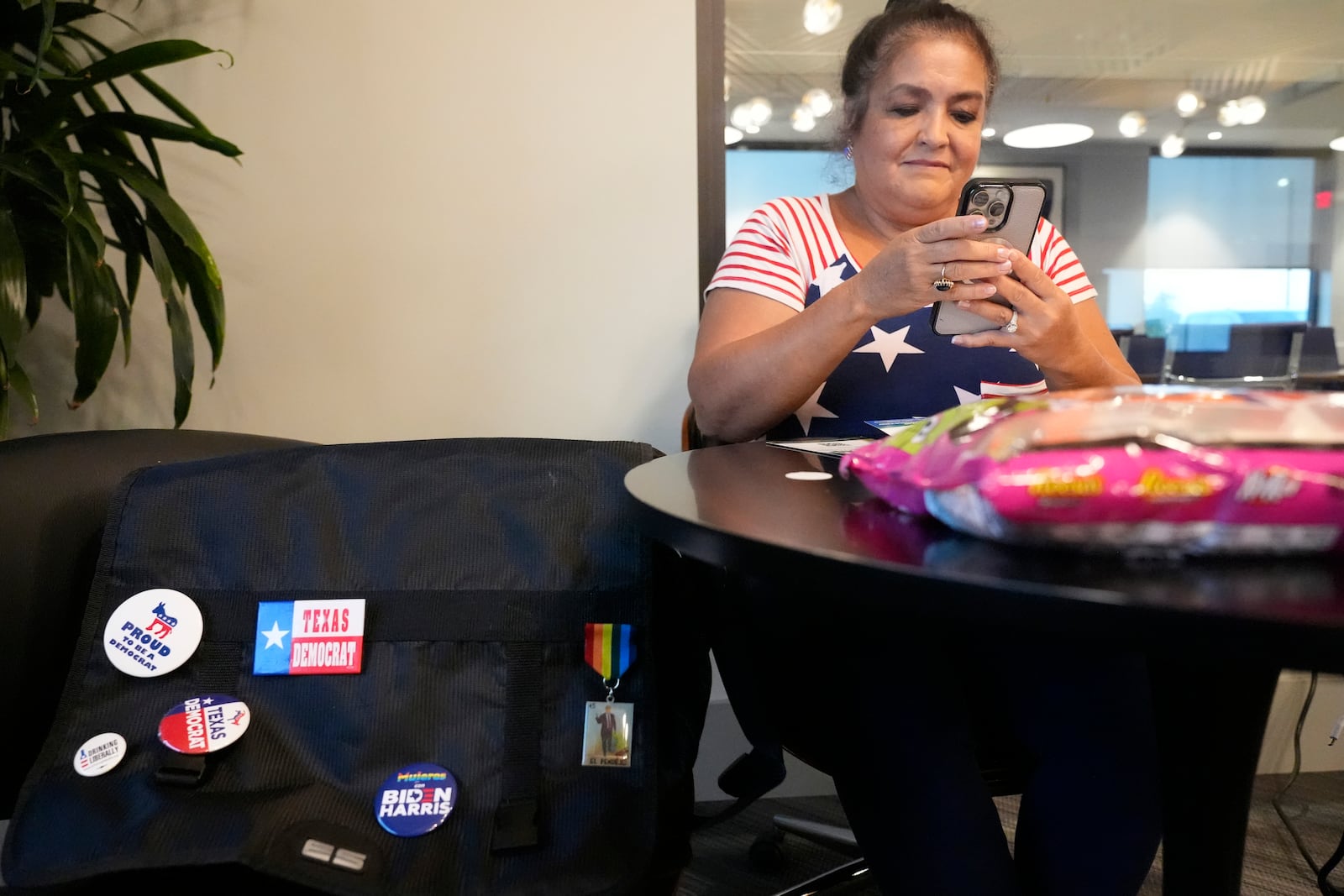 Sally Ortega Putney works a volunteer phone bank calling potential voters in Flower Mound, Texas, Wednesday, Oct. 2, 2024. (AP Photo/LM Otero)