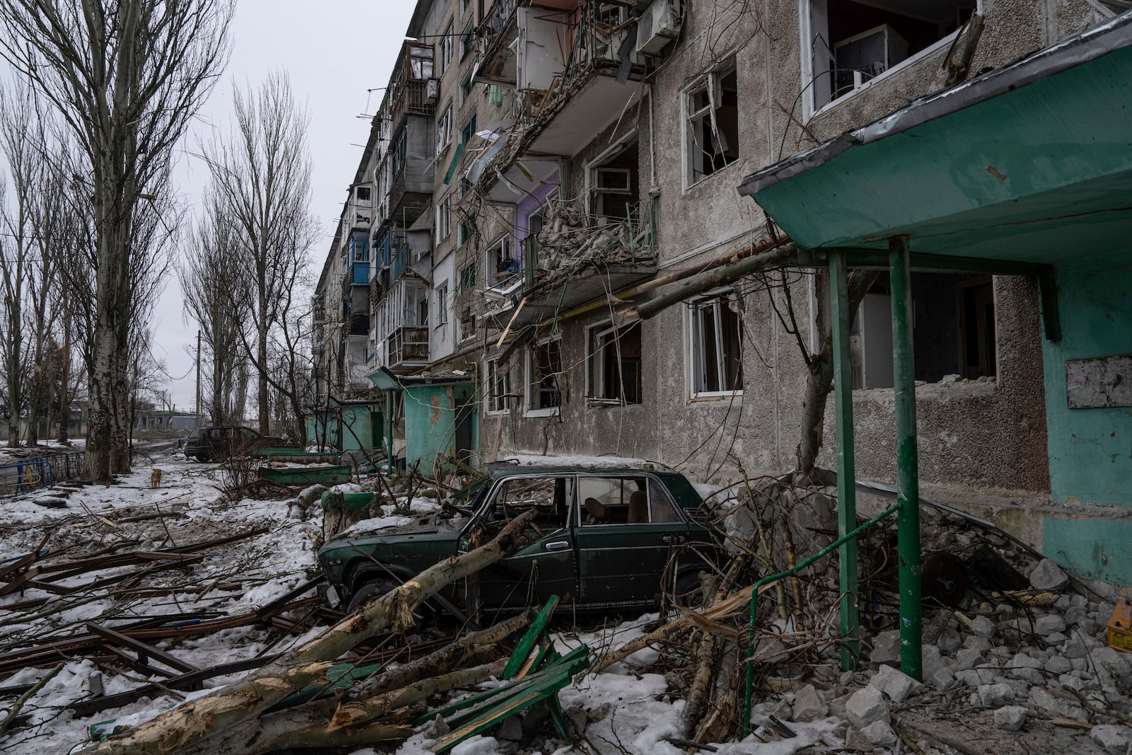 FILE - A destroyed car is seen in front of a residential building which was heavily bombed by Russian forces, in the frontline city of Vuhledar, Ukraine, Feb. 25, 2023. (AP Photo/Evgeniy Maloletka, File)