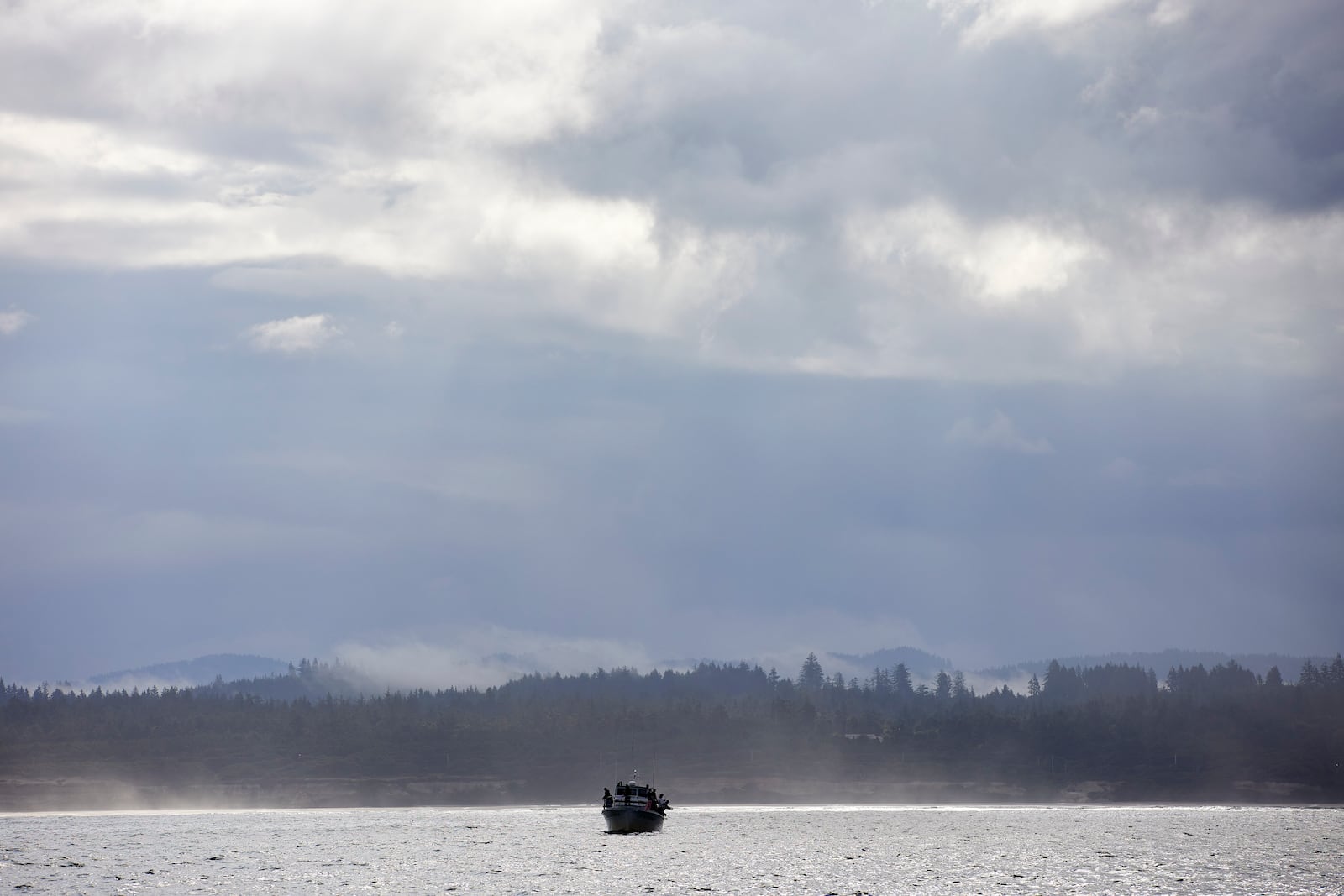 Fishermen fish in the Pacific Ocean near the wave energy test site in Newport, Ore., Friday, Aug. 23, 2024, where private developers will be able to test devices that they've designed to harness energy from waves. (AP Photo/Craig Mitchelldyer)