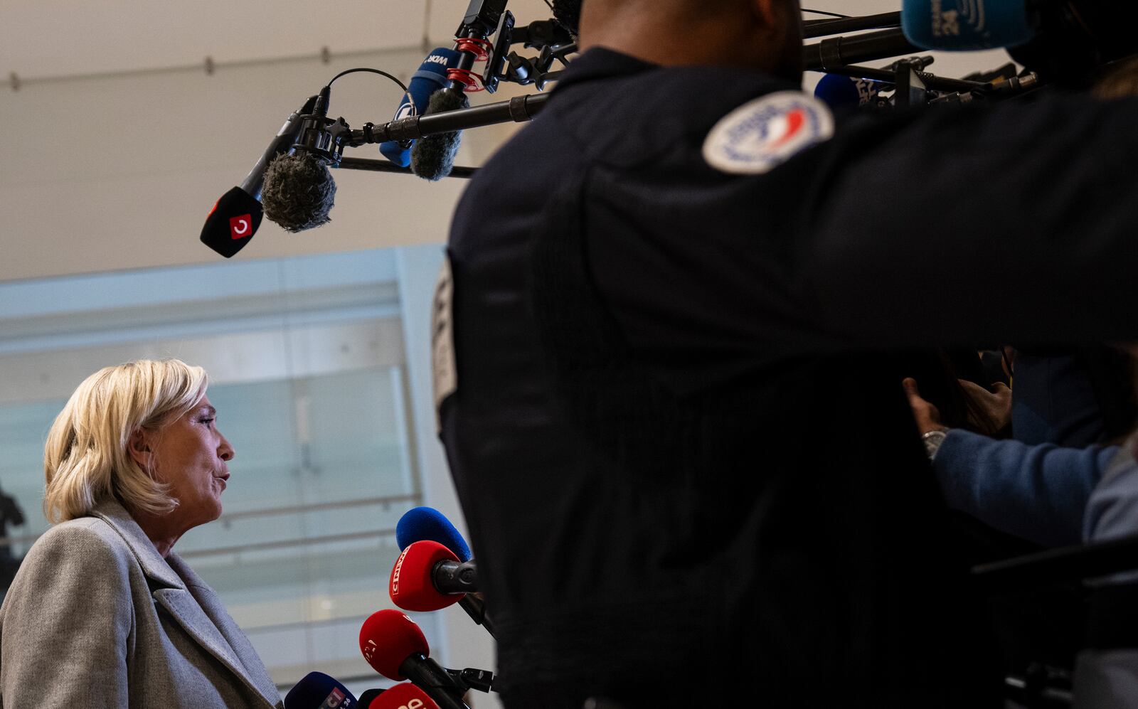 French far-right leader Marine Le Pen speaks to the media as she arrives at the court house in Paris, Monday, Sept. 30, 2024. (AP Photo/Louise Delmotte)