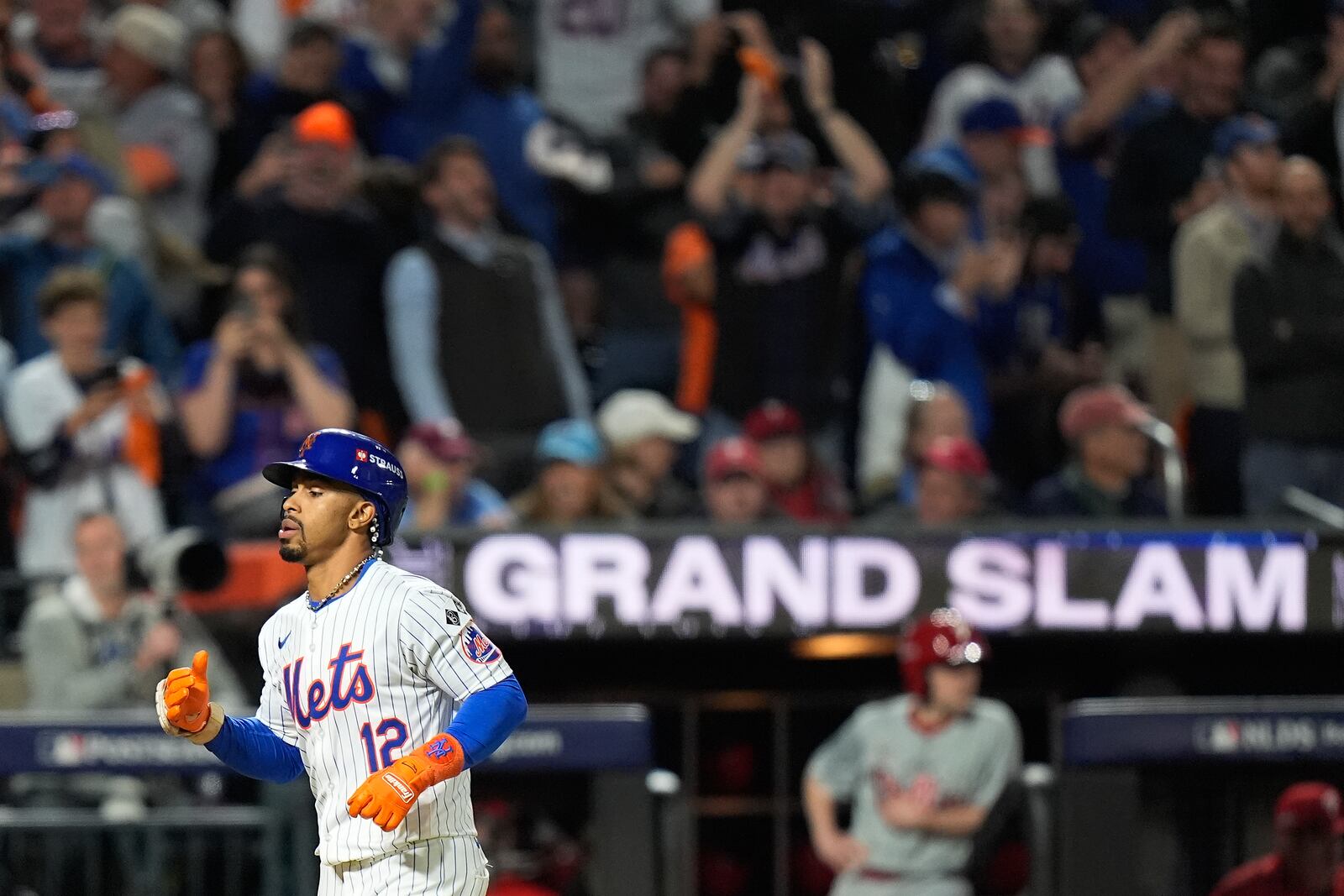 New York Mets' Francisco Lindor (12) rounds the bases after hitting a grand slam home run against the Philadelphia Phillies during the sixth inning of Game 4 of the National League baseball playoff series, Wednesday, Oct. 9, 2024, in New York. (AP Photo/Frank Franklin II)