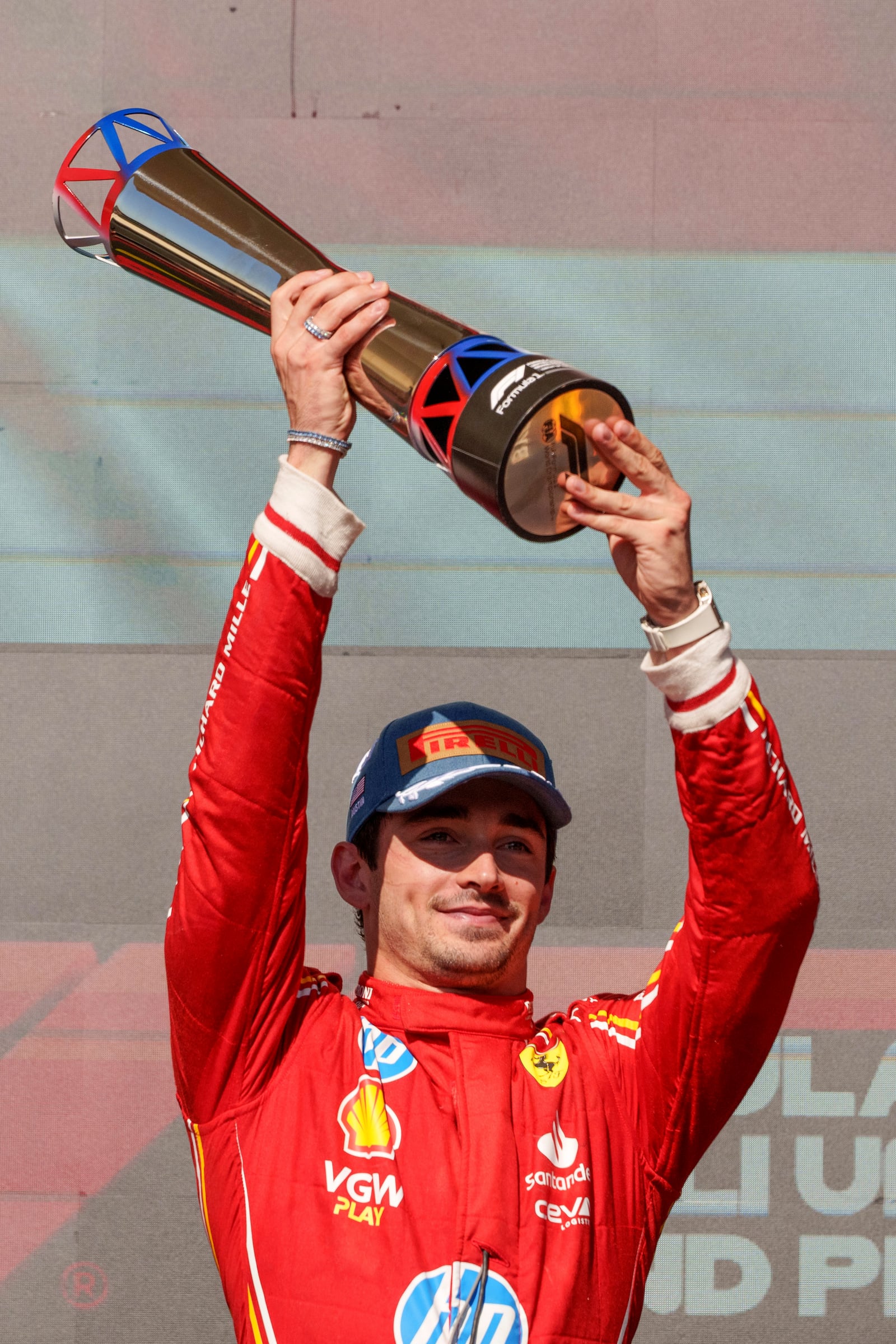 Ferrari driver Charles Leclerc, of Monaco, holds the trophy after winning the U.S. Grand Prix auto race at Circuit of the Americas, Sunday, Oct. 20, 2024, in Austin, Texas. (AP Photo/Nick Didlick)