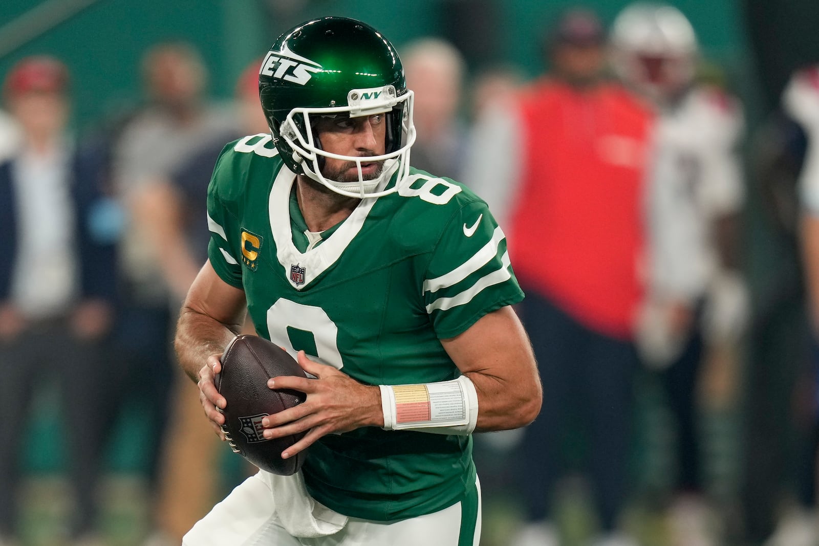 New York Jets quarterback Aaron Rodgers (8) steps back to pass against the New England Patriots during the first quarter of an NFL football game, Thursday, Sept. 19, 2024, in East Rutherford, N.J. (AP Photo/Seth Wenig)