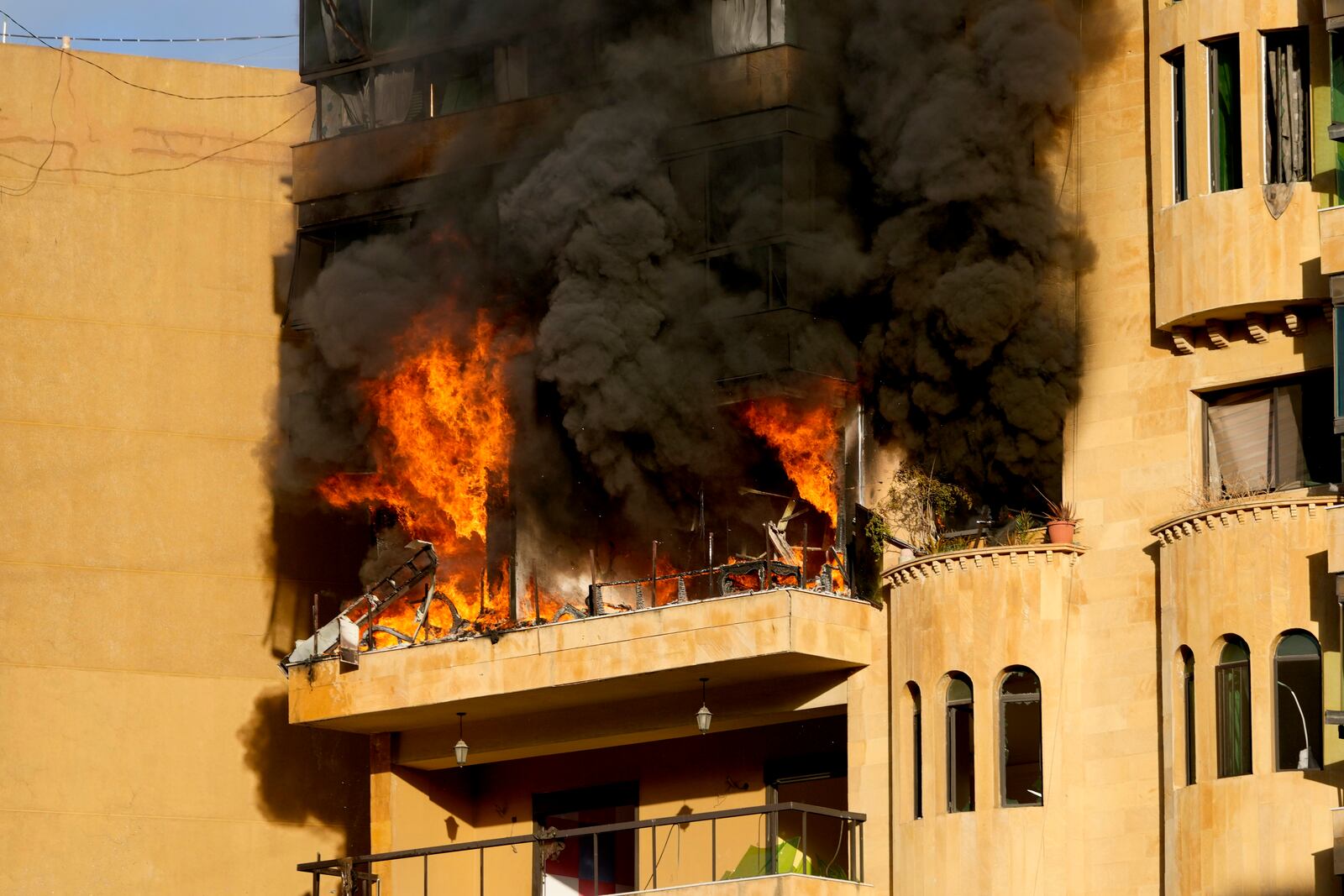 Flames rise from an apartment which caught fire after an Israeli airstrike in Dahieh, Beirut, Lebanon, Wednesday, Oct. 2, 2024. (AP Photo/Hussein Malla)