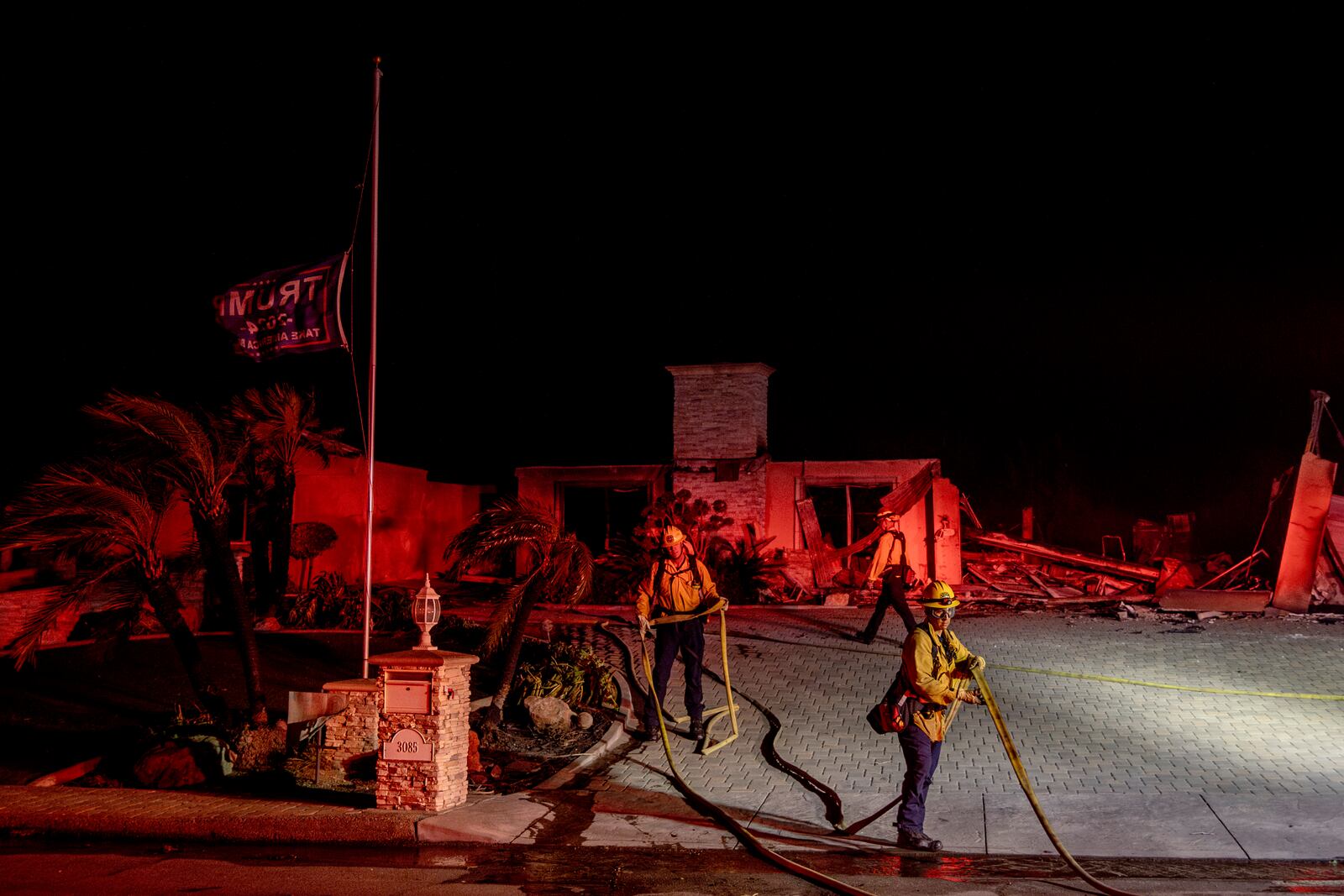 Firefighters with the Culver City Fire Department extinguish hot spots at a home destroyed by the Mountain Fire in Camarillo, Calif., Wednesday, Nov. 6, 2024. (Stephen Lam/San Francisco Chronicle via AP)