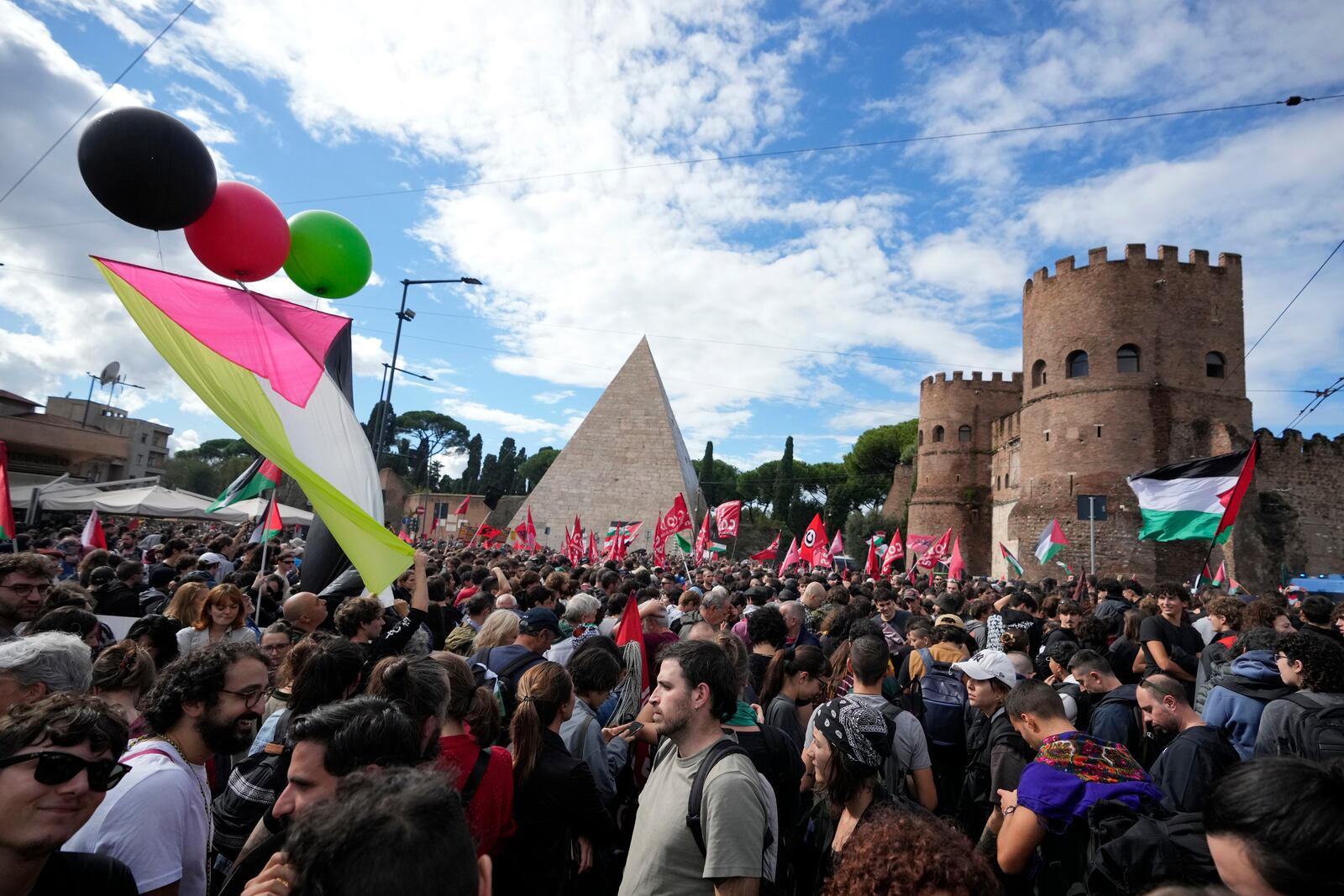 People attend at a protest in Rome, Saturday, Oct. 5, 2024. Pro-palestinians people take to the street in an unauthorised march in the centre of Rome two days ahead of the first anniversary of the Oct. 7. (AP Photo/Andrew Medichini)