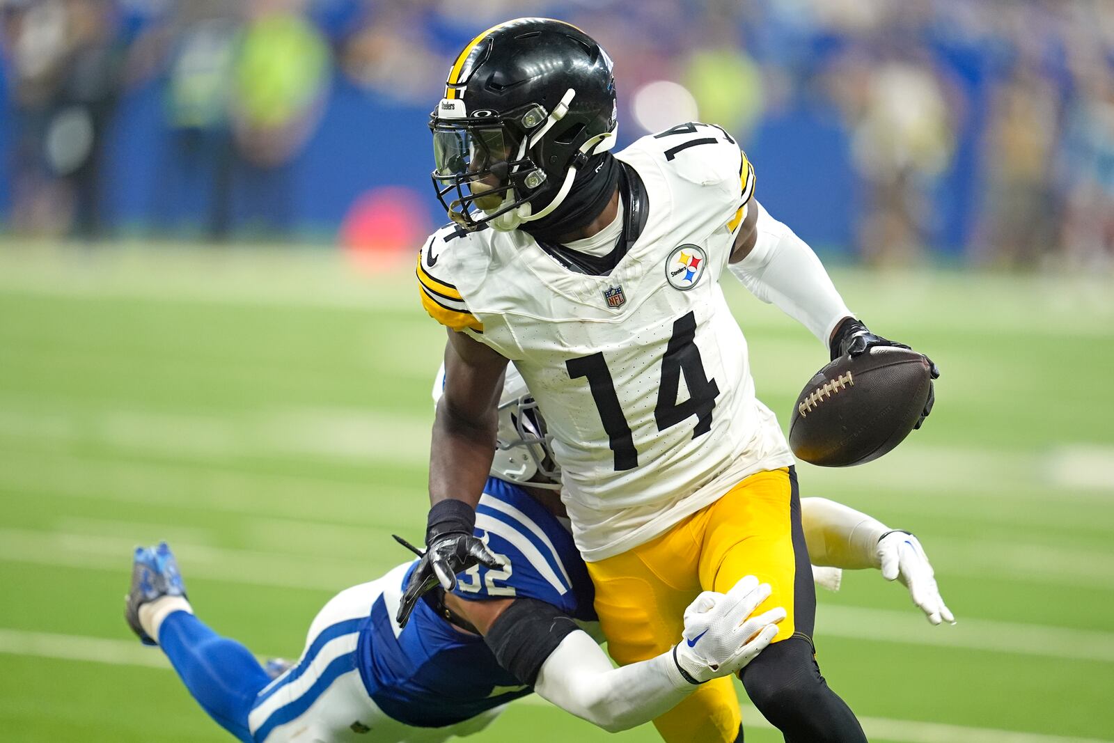 Pittsburgh Steelers wide receiver George Pickens (14) is tackled by Indianapolis Colts safety Julian Blackmon (32) after making a catch during the second half of an NFL football game Sunday, Sept. 29, 2024, in Indianapolis. (AP Photo/Michael Conroy)