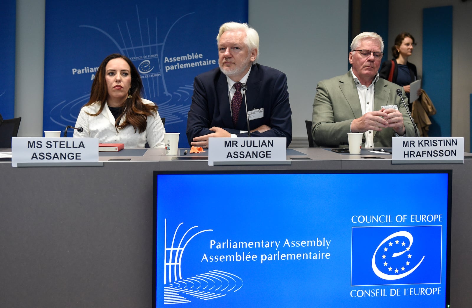 Wikileaks founder Julian Assange, center, his wife Stella Assange, left, and editor-in-chief of WikiLeaks Kristin Hrafnsson, listen the open speech at the Council of Europe while his wife Stella Assange sits next to him, in Strasbourg, eastern France, Tuesday, Oct. 1, 2024. (AP Photo/Pascal Bastien)