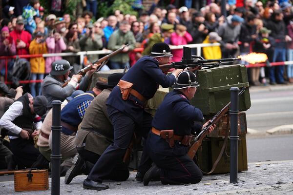 History enthusiasts take part in a reenactment of a battle, which was part of the Pragues Uprising, marking the 80th anniversary of the end of the WWII in Prague, Czech Republic, Thursday, May 8, 2025. (AP Photo/Petr David Josek)