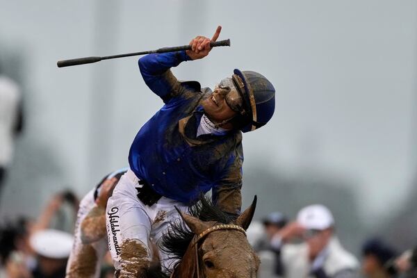Jockey Junior Alvarado celebrates after riding Sovereignty to victory in the 151st running of the Kentucky Derby horse race at Churchill Downs Saturday, May 3, 2025, in Louisville, Ky. (AP Photo/Brynn Anderson)