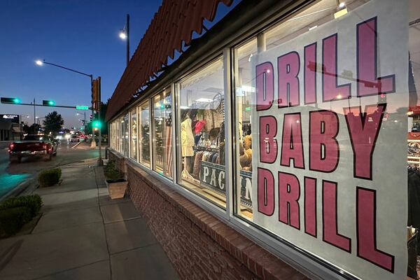 A sign in support of the oil and natural gas industry is displayed in a shop window along a main street in Carlsbad, N.M., on Tuesday, May 20, 2025. (AP Photo/Susan Montoya Bryan)