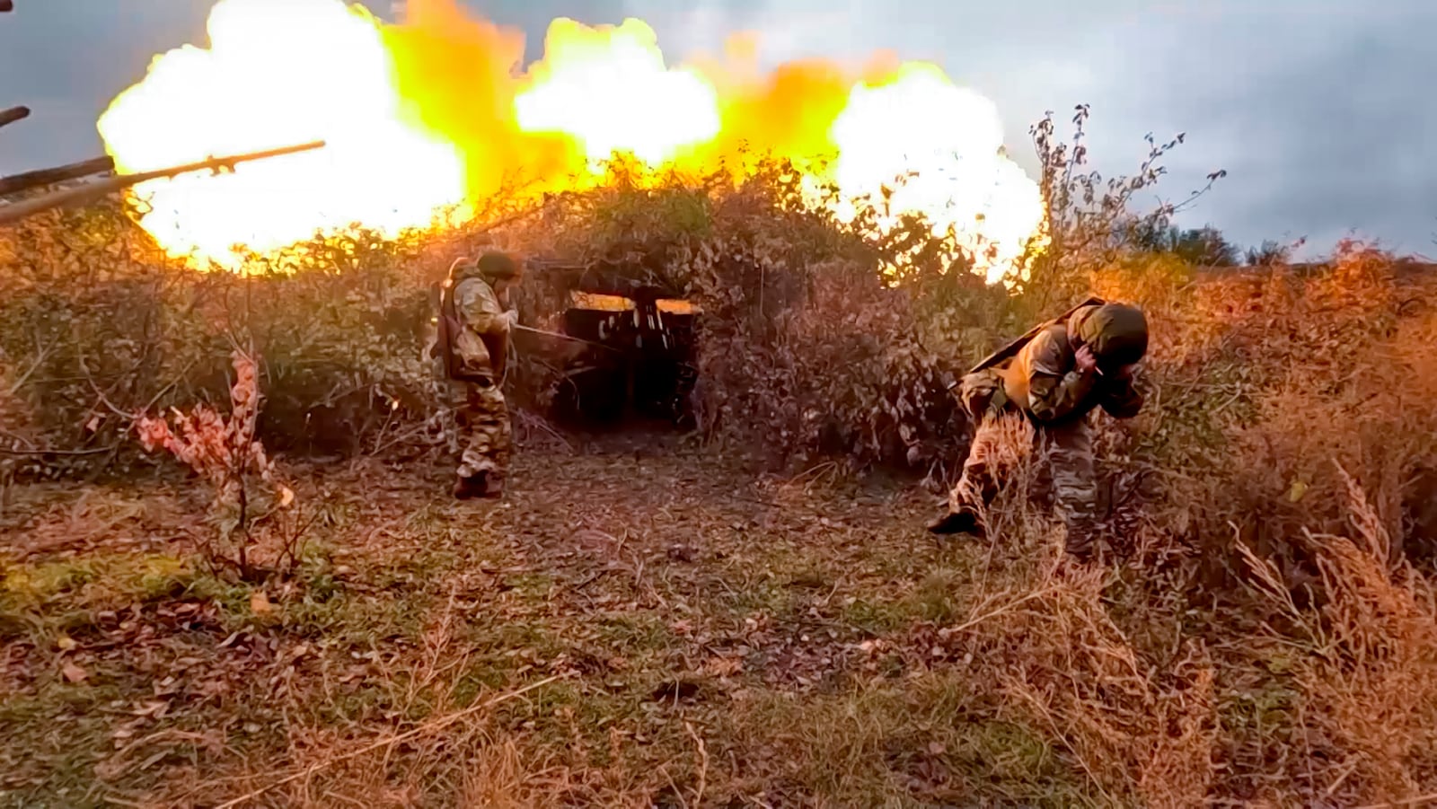 In this photo taken from video distributed by Russian Defense Ministry Press Service on Wednesday, Oct. 30, 2024, Russian soldiers fire a 152 mm gun Giatsint-B from their position at an undisclosed location in Ukraine. (Russian Defense Ministry Press Service via AP)